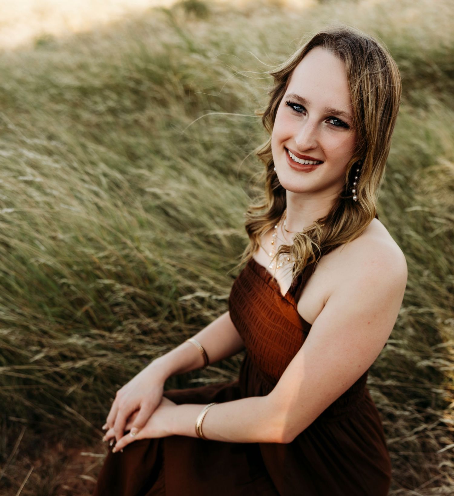 Close-up outdoor senior portrait of a Class of 2027 senior in a brown dress during a golden hour session in Abilene, Texas.