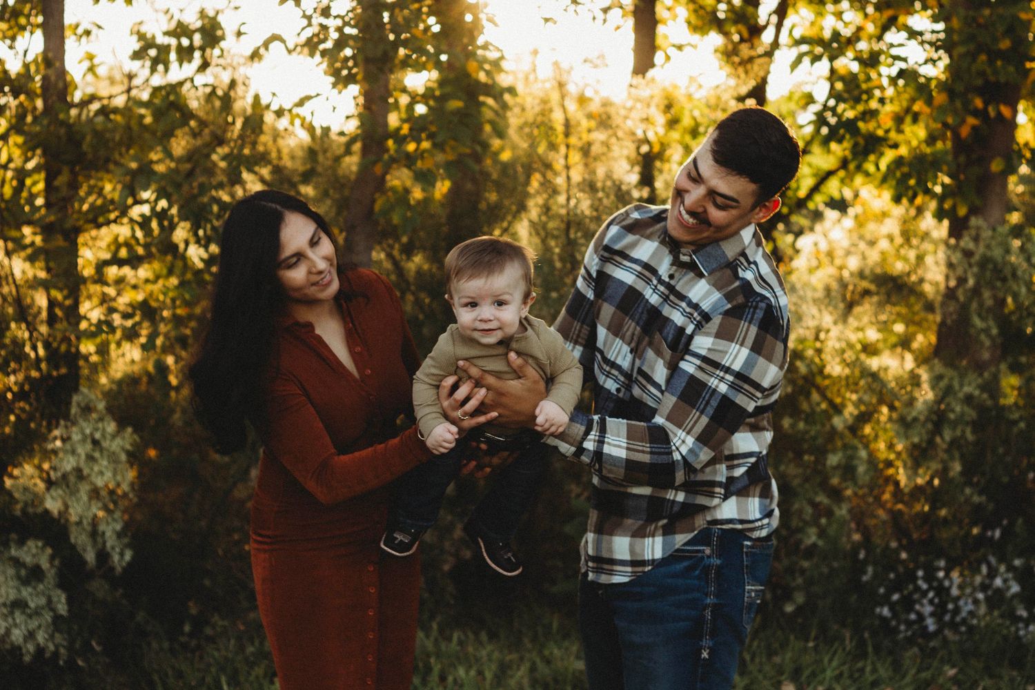 family laughing together during a golden hour outdoor family portrait session in Abilene TX