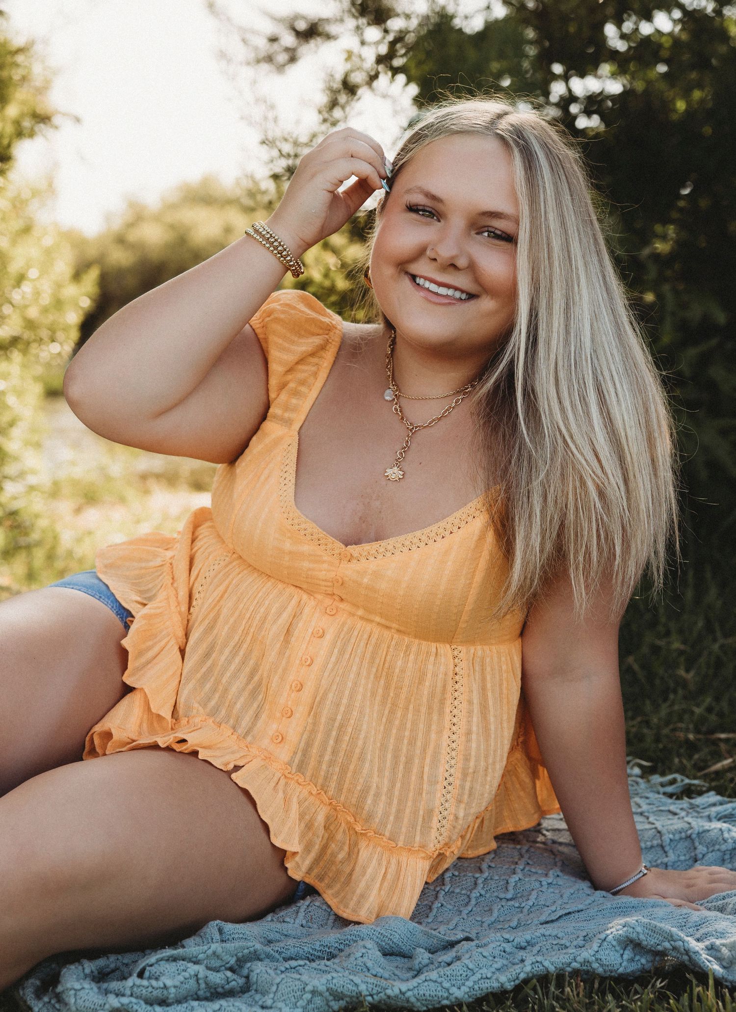 Outdoor senior photos of a Class of 2027 senior in a yellow top and cowboy boots during a golden hour senior portrait session in Abilene, Tx