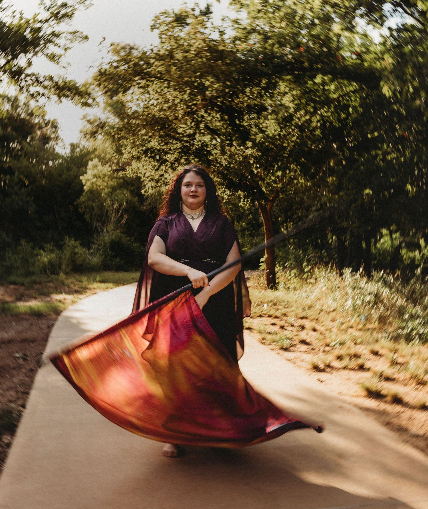 High school senior twirling a color guard flag in Abilene Texas