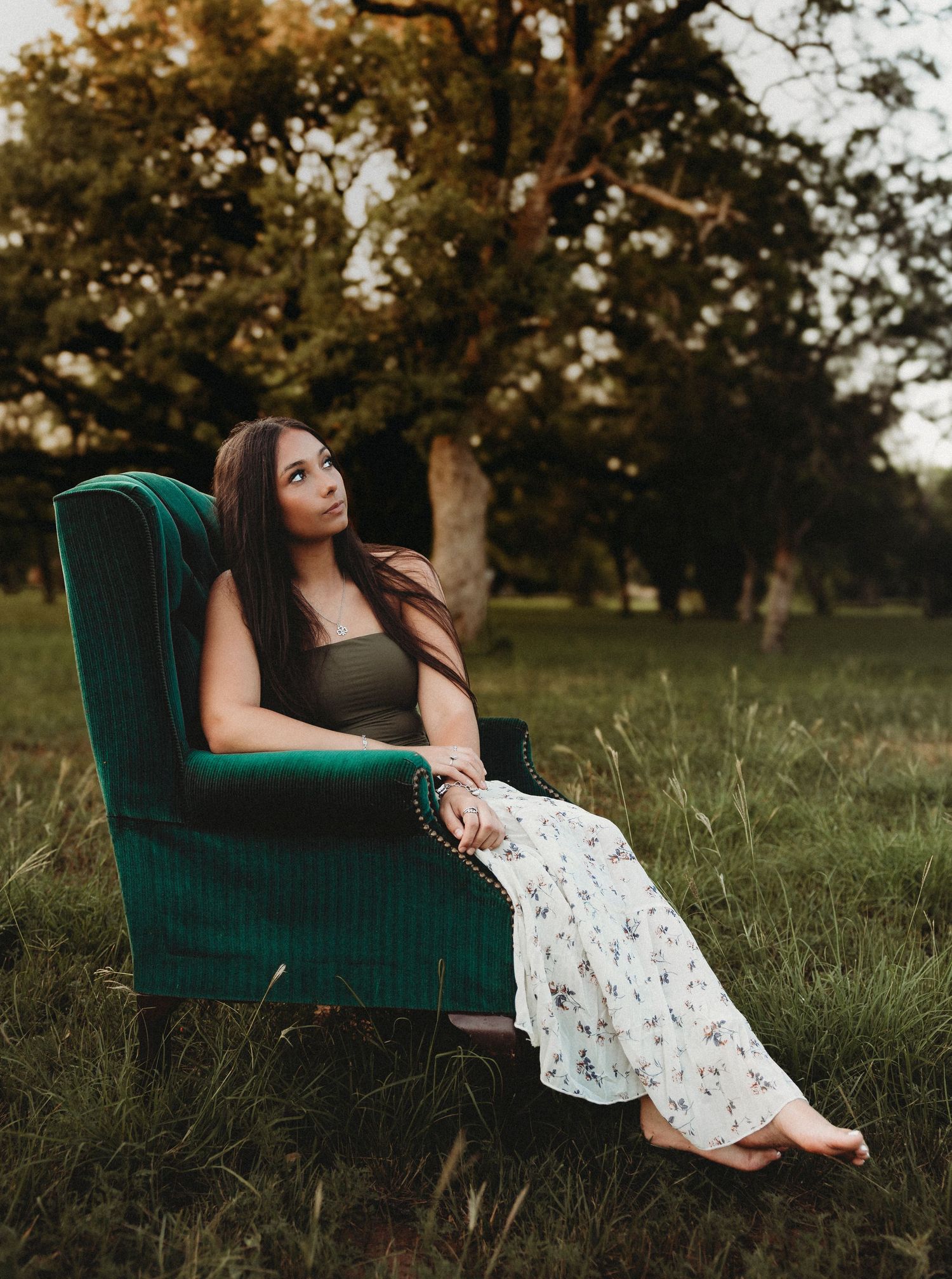 Class of 2027 senior portraits on a vintage chair during a golden hour senior session in Abilene, Texas.