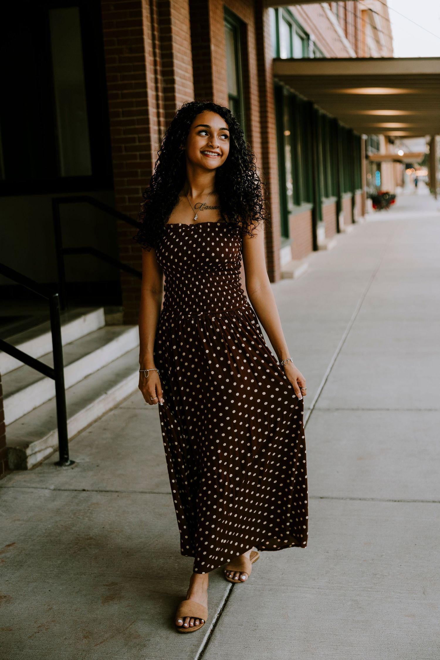 Cooper High School senior walking through historic downtown Abilene, Texas during an outdoor senior photography session.