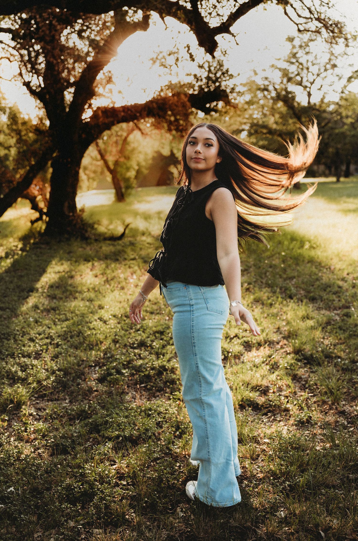 Class of 2027 senior photos walking through golden hour light during a senior session in Abilene, Texas.