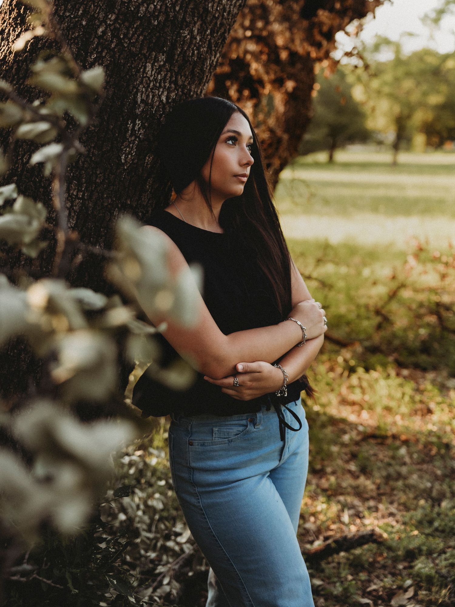 Class of 2027 senior photos beneath oak trees during a golden hour senior session in Abilene, Texas.