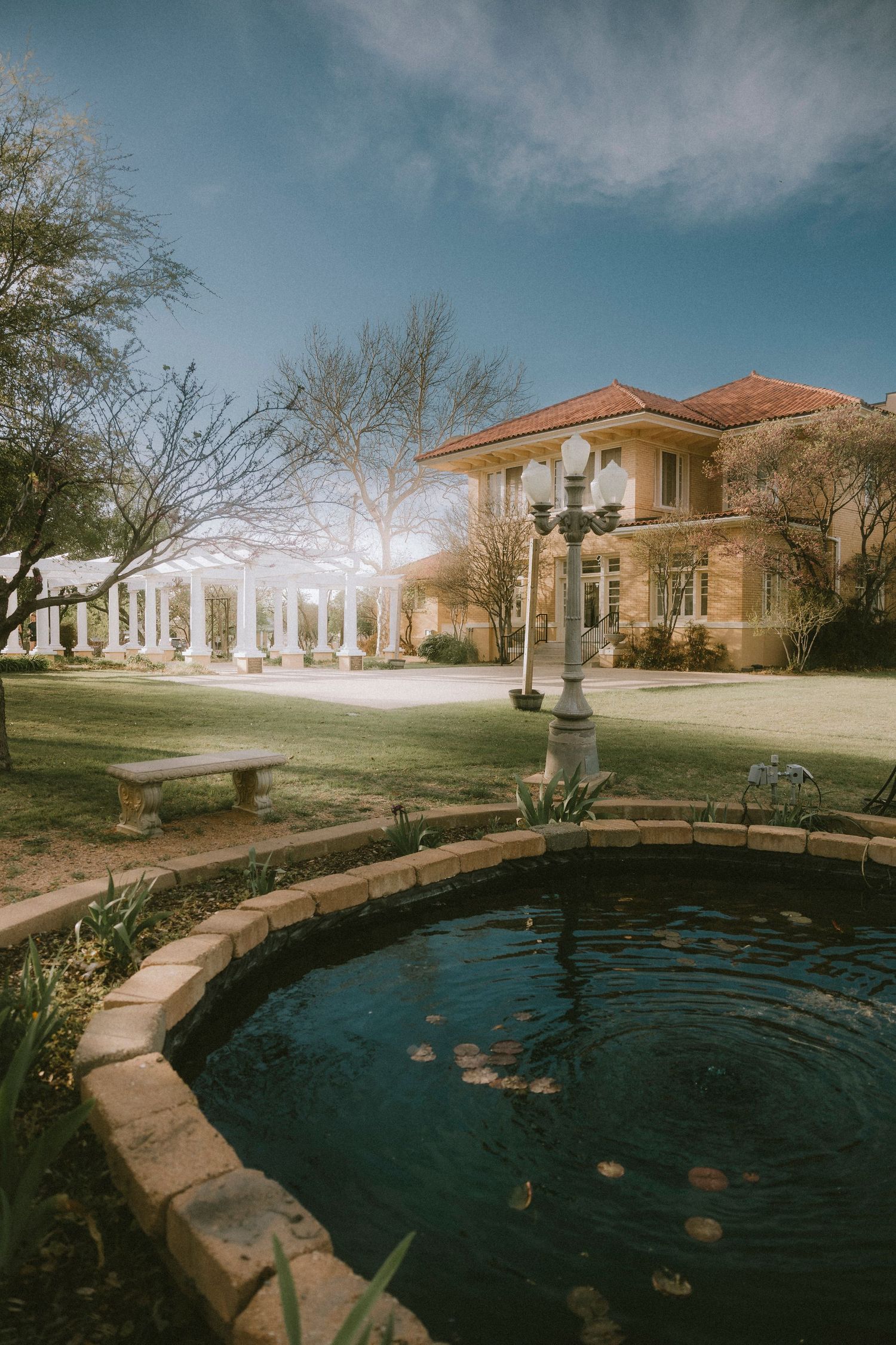 Swenson House and pond at sunset with a dreamy vintage vibe in Abilene, TX