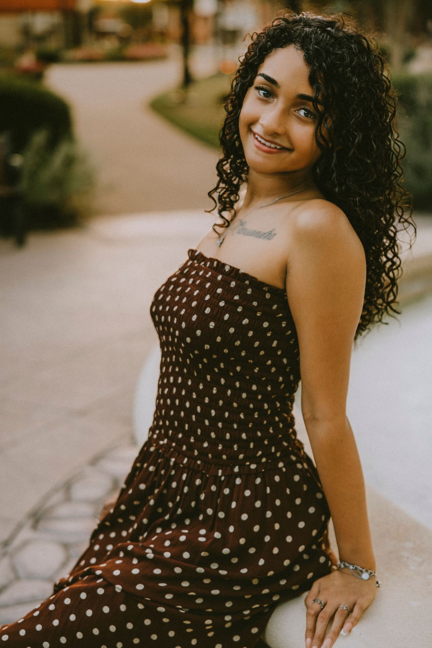 Close-up portrait of a Cooper High School senior smiling during a golden hour senior photography session in downtown Abilene, Texas.