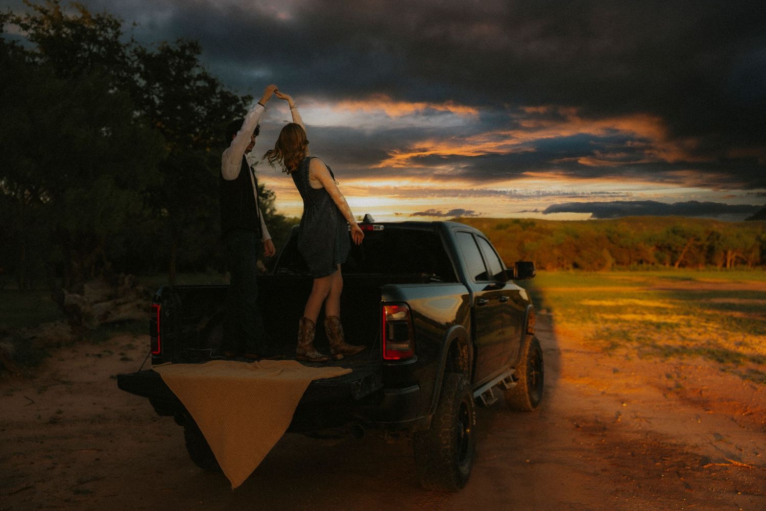 Couple dancing in truck in Abilene TX at sunset