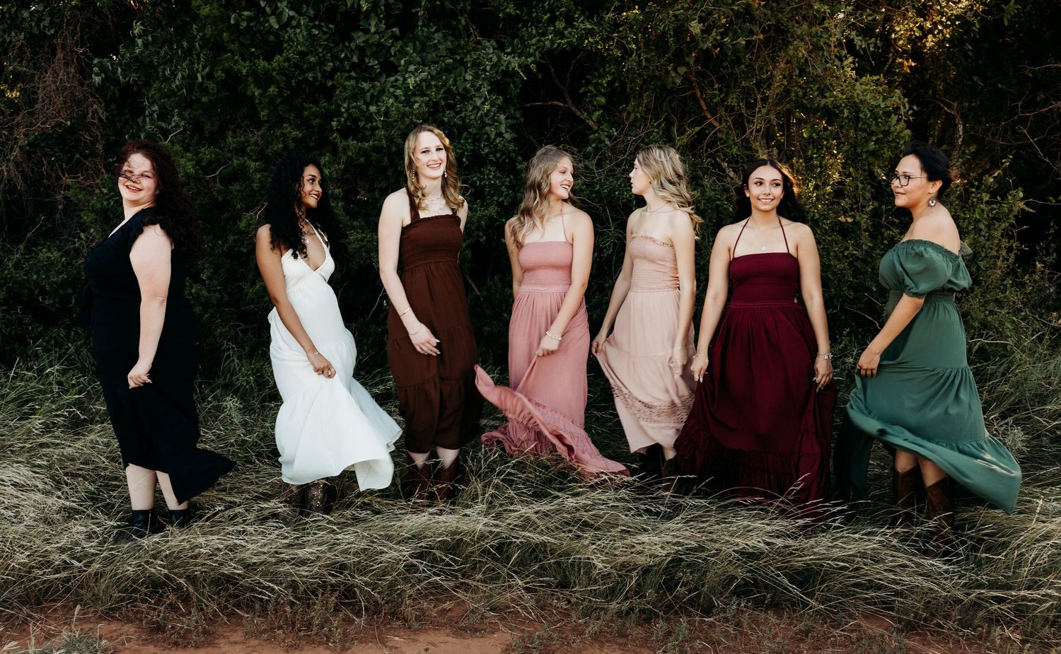 Class of 2027 Senior Rep Team posing together in flowing dresses during an outdoor senior portraits session in Abilene, Texas.