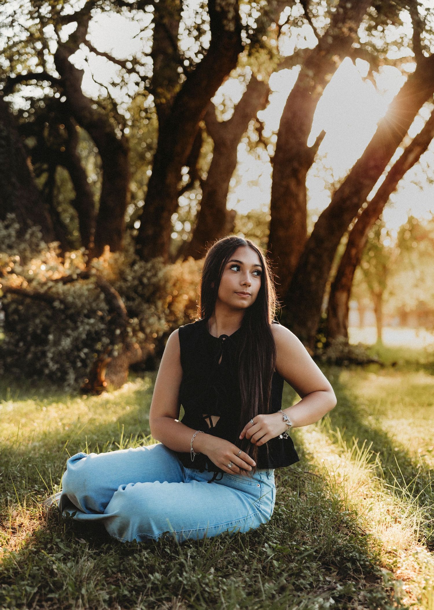 Class of 2027 senior portraits beneath oak trees during a golden hour senior session in Abilene, Texas.