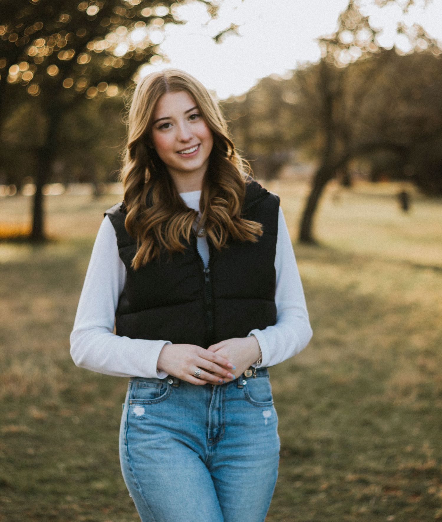 Senior photoshoot in a field at golden hour in Buffalo Gap