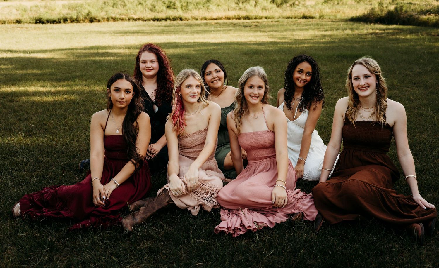 Shadow & Light Portraits Class of 2027 Senior Rep Team group portrait featuring high school seniors in flowing dresses during a golden hour