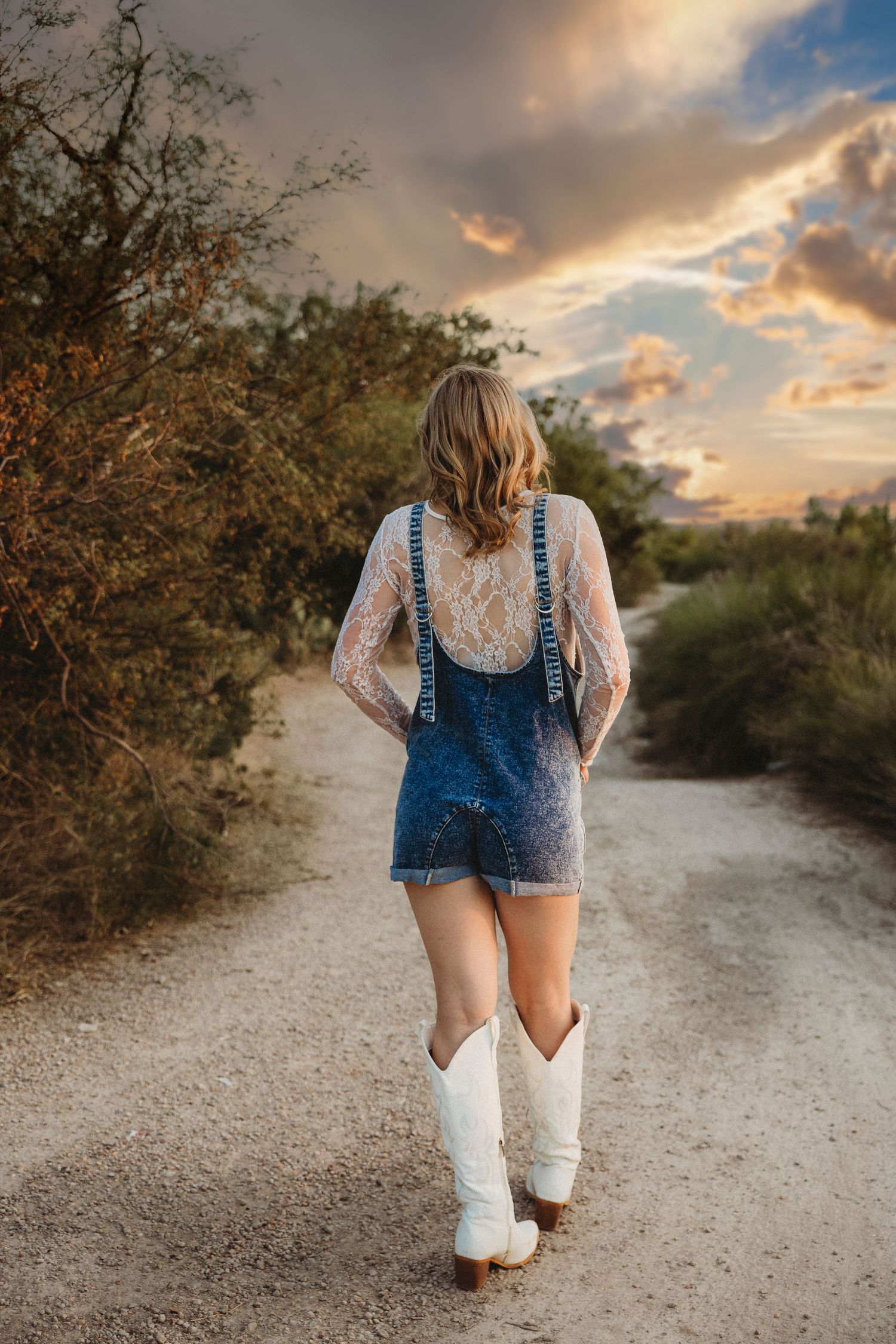 Class of 2027 senior walking down a country road during a golden hour senior session in Abilene, Texas.