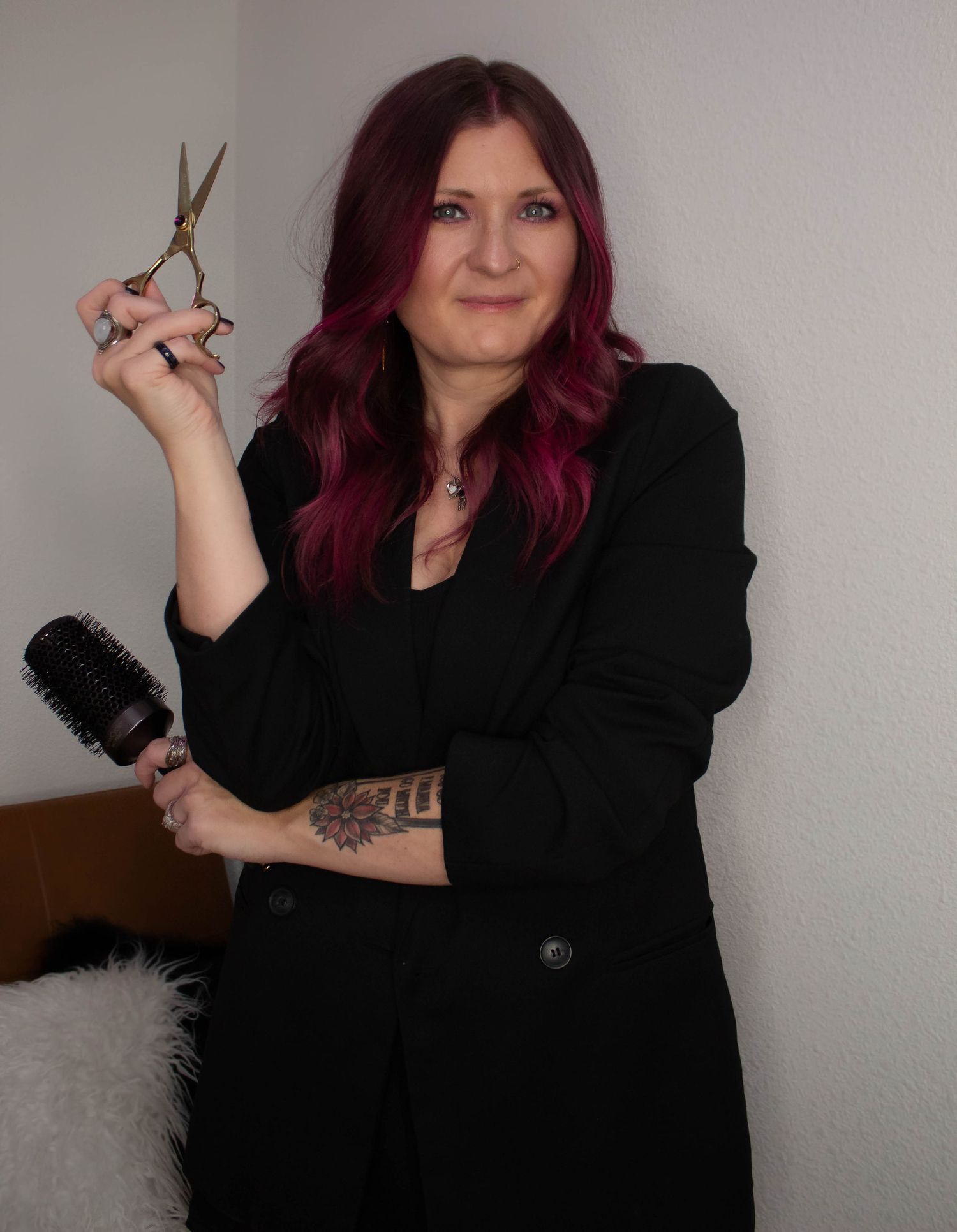 Personal branding portrait session in Abilene TX featuring a business owner holding hairstyling tools in a studio setting