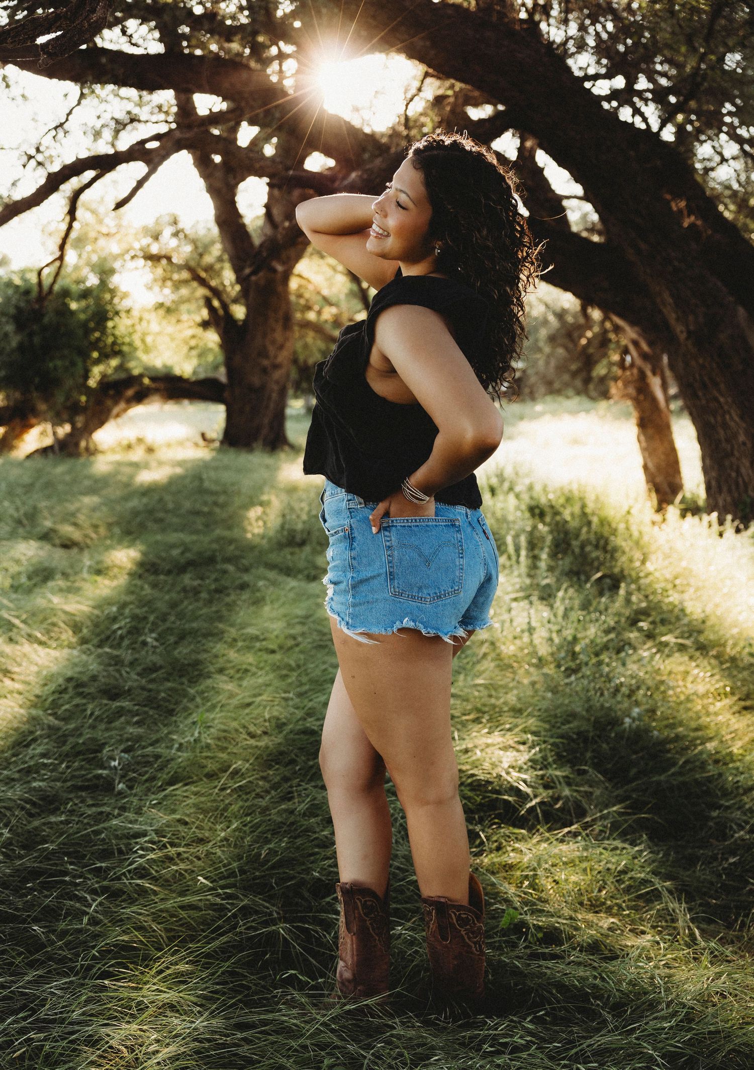 Senior portrait at sunset under trees during Abilene Texas senior session