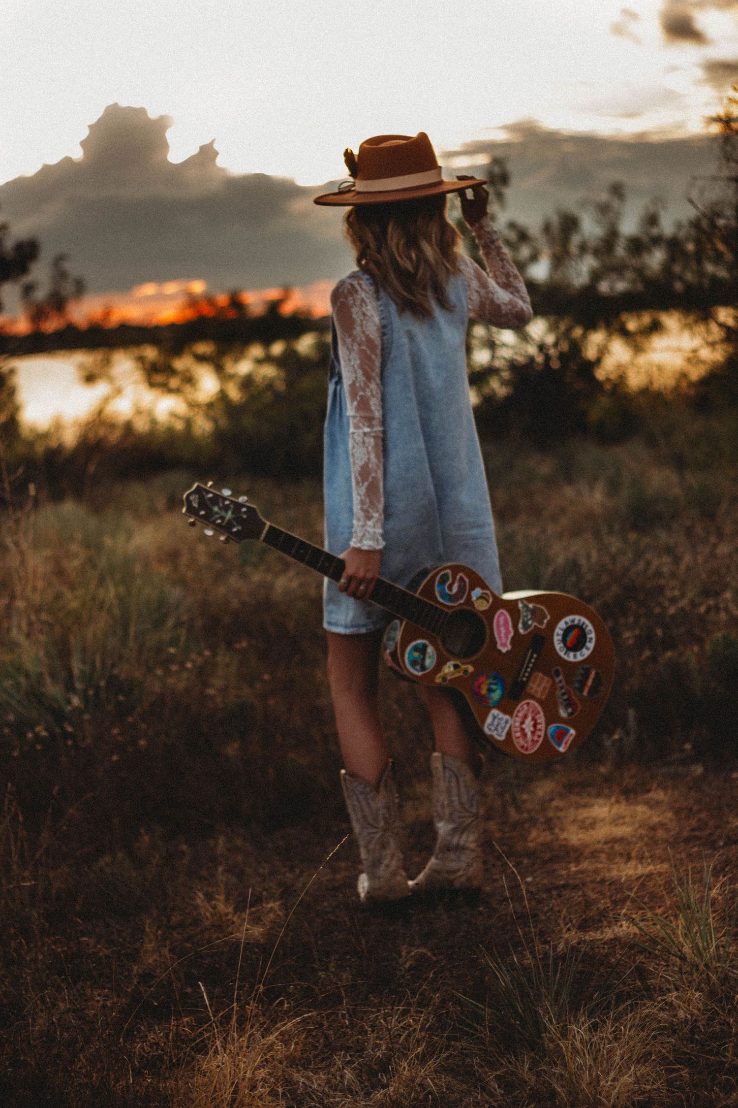 Abilene TX senior portrait session featuring a high school senior with guitar during golden hour outdoors