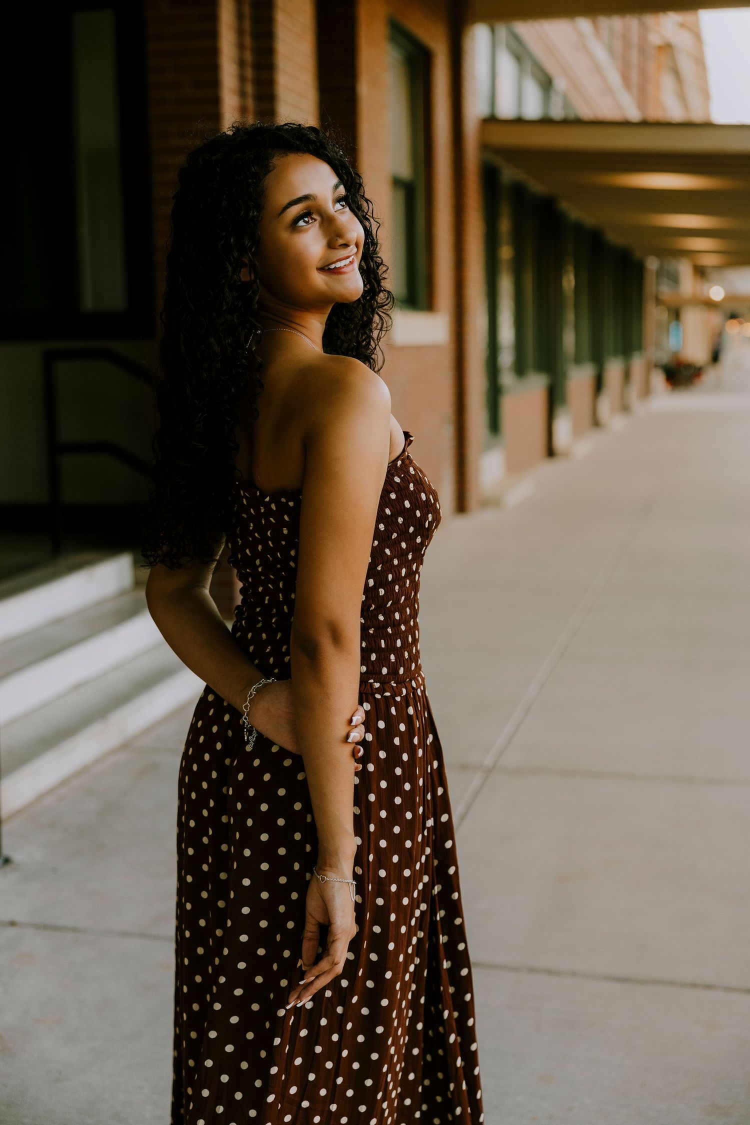 Class of 2027 Cooper High School senior posing at dusk in downtown Abilene during an outdoor senior photography session.