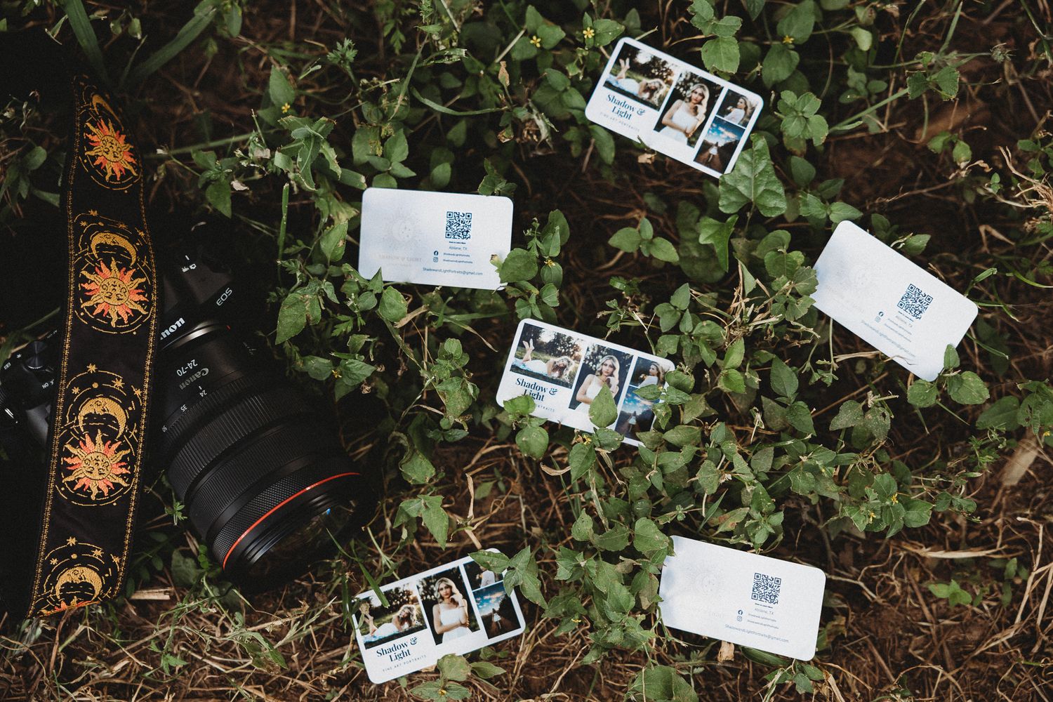 Flat lay of camera gear, photo strips, and creative tools styled outdoors for photographer branding and storytelling.