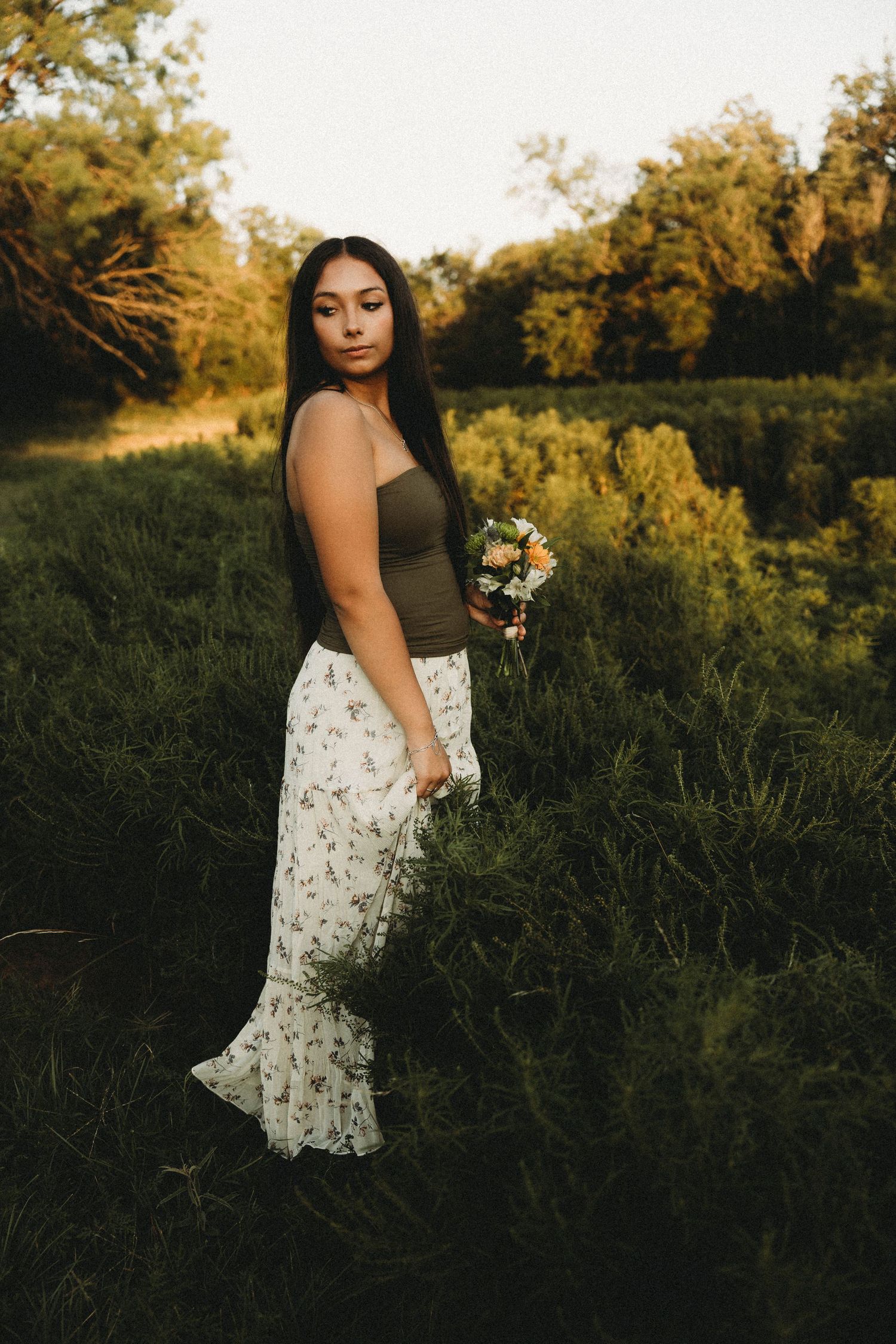 Class of 2027 senior in a floral dress during a golden hour outdoor senior session in Abilene, Texas.