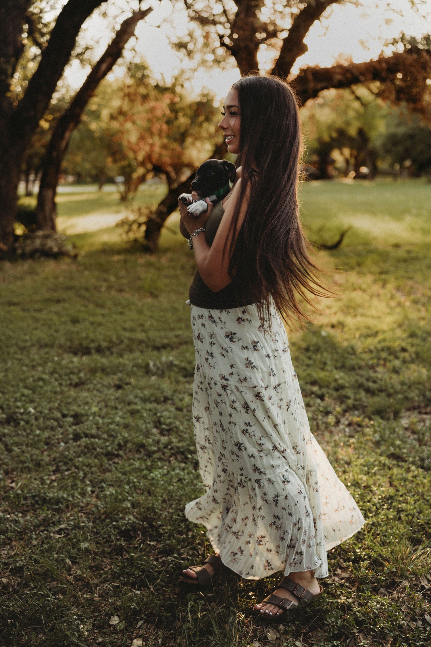 Back view of a Class of 2027 senior in a floral dress during a golden hour senior session in Abilene, Texas.