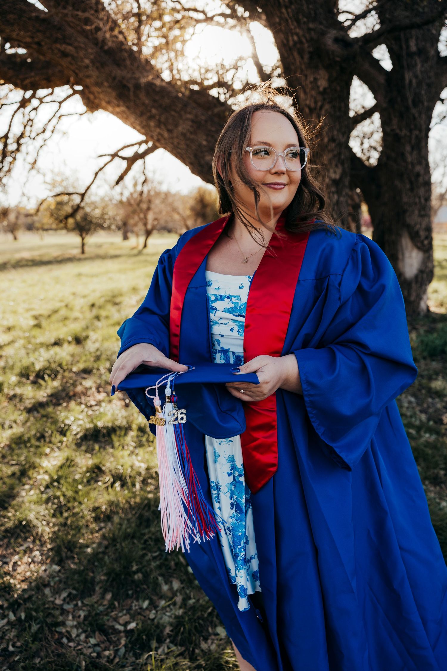 Cooper senior Graduate in cap and gown during sunset golden hour