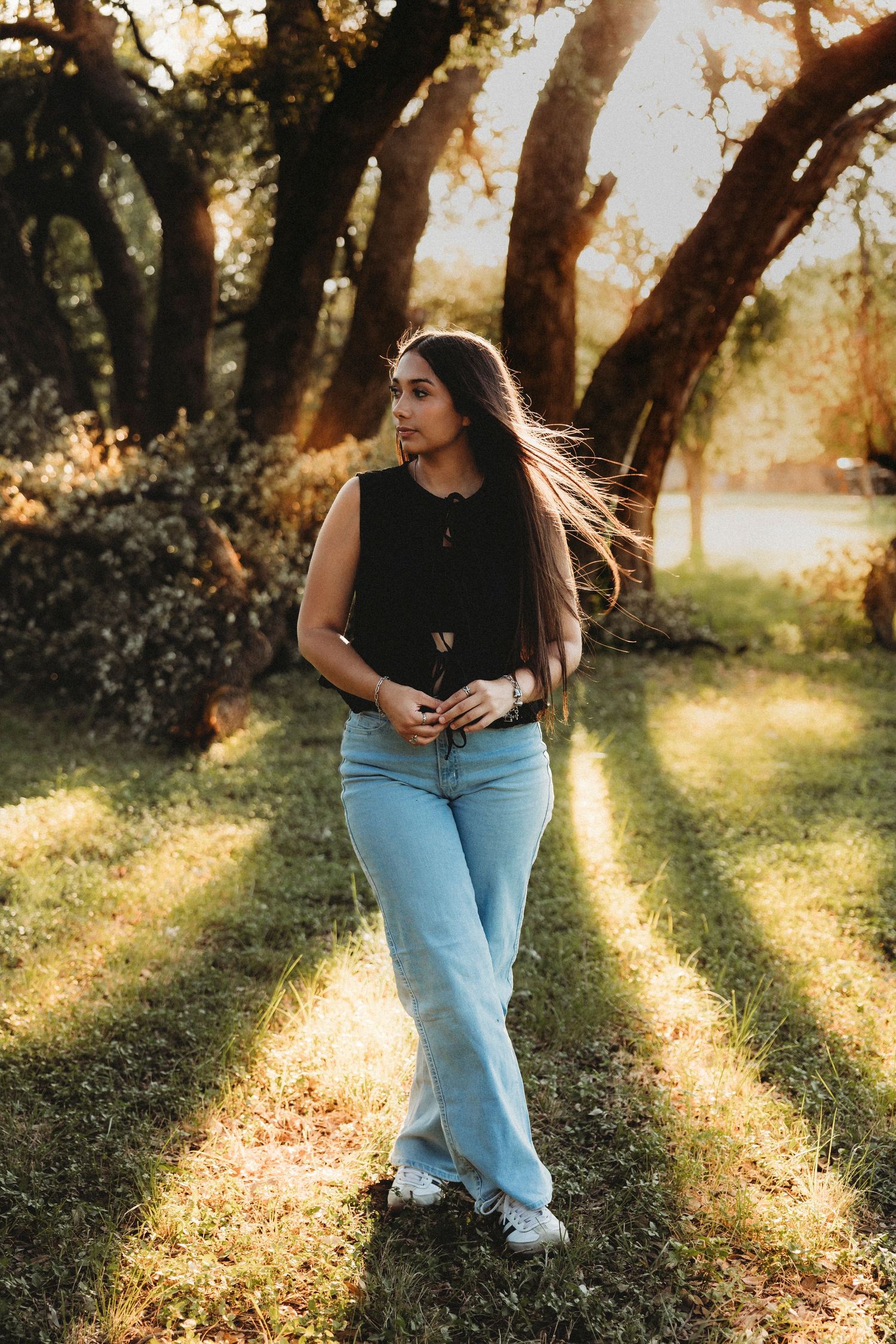 Class of 2027 senior portraits beneath oak trees during a golden hour senior session in Abilene, Texas.