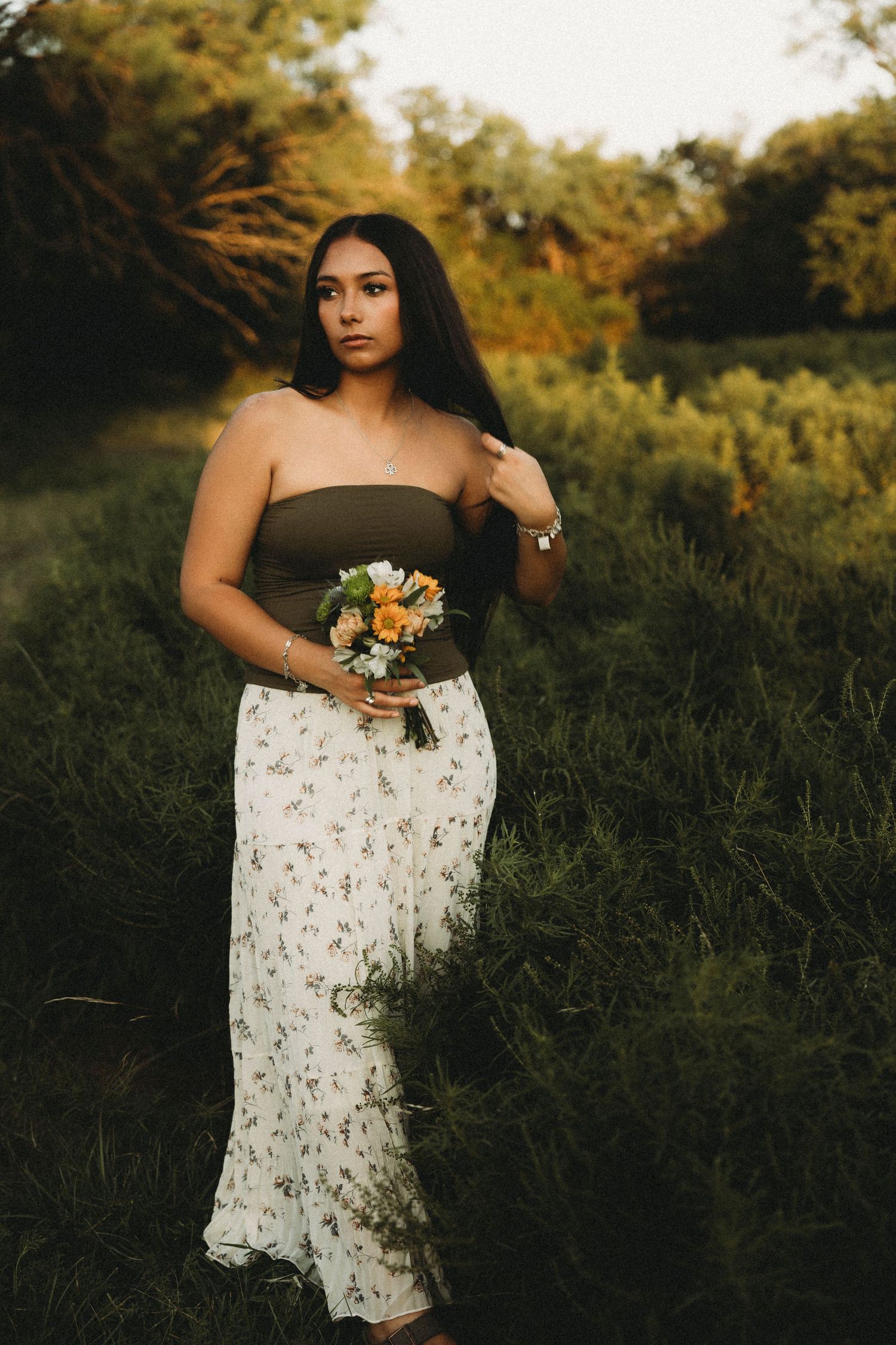 Class of 2027 senior in a floral dress during a golden hour outdoor senior session in Abilene, Texas.