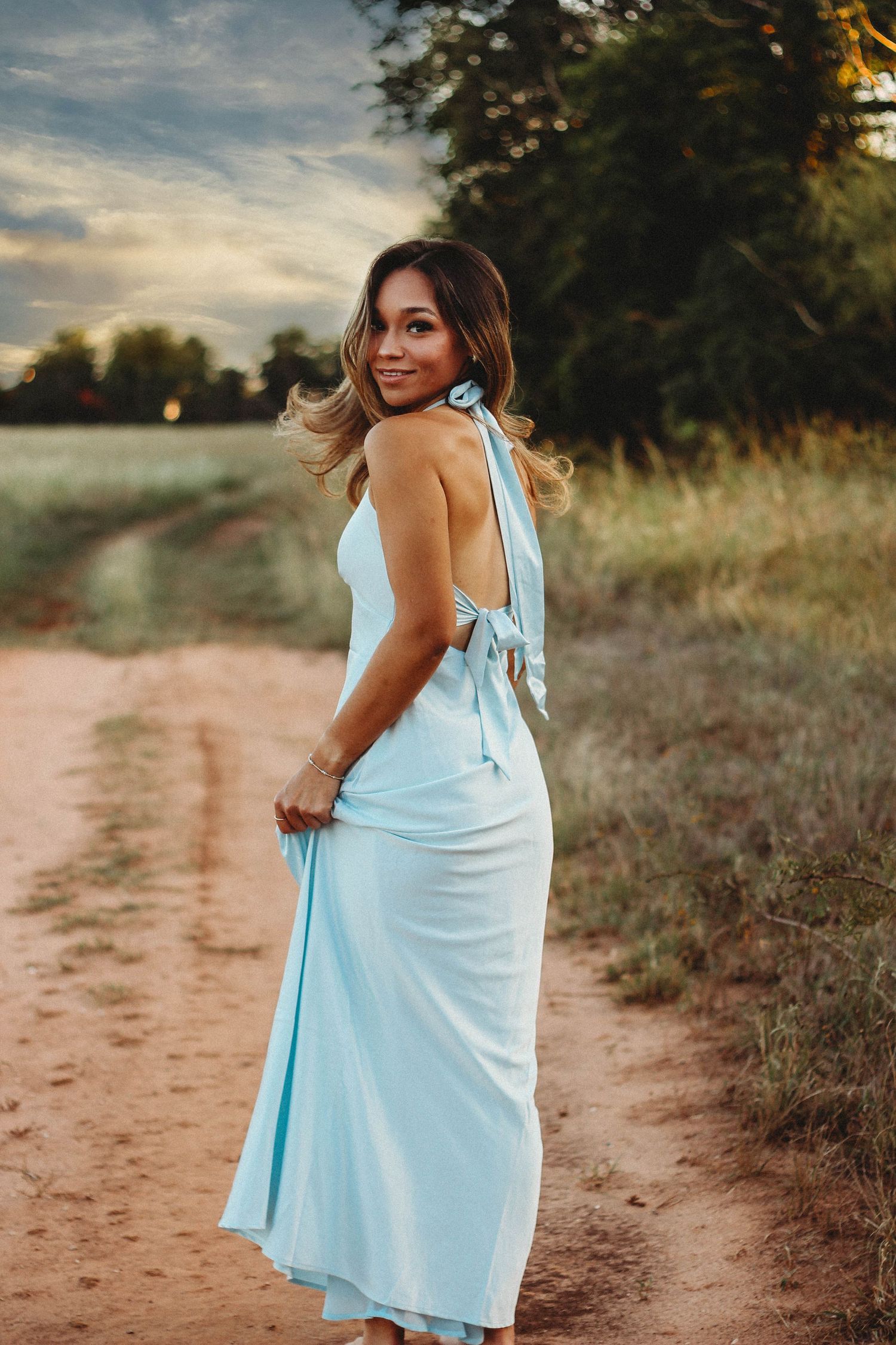 21st birthday portrait session in Abilene TX featuring an outdoor sunset photoshoot with flowing dress