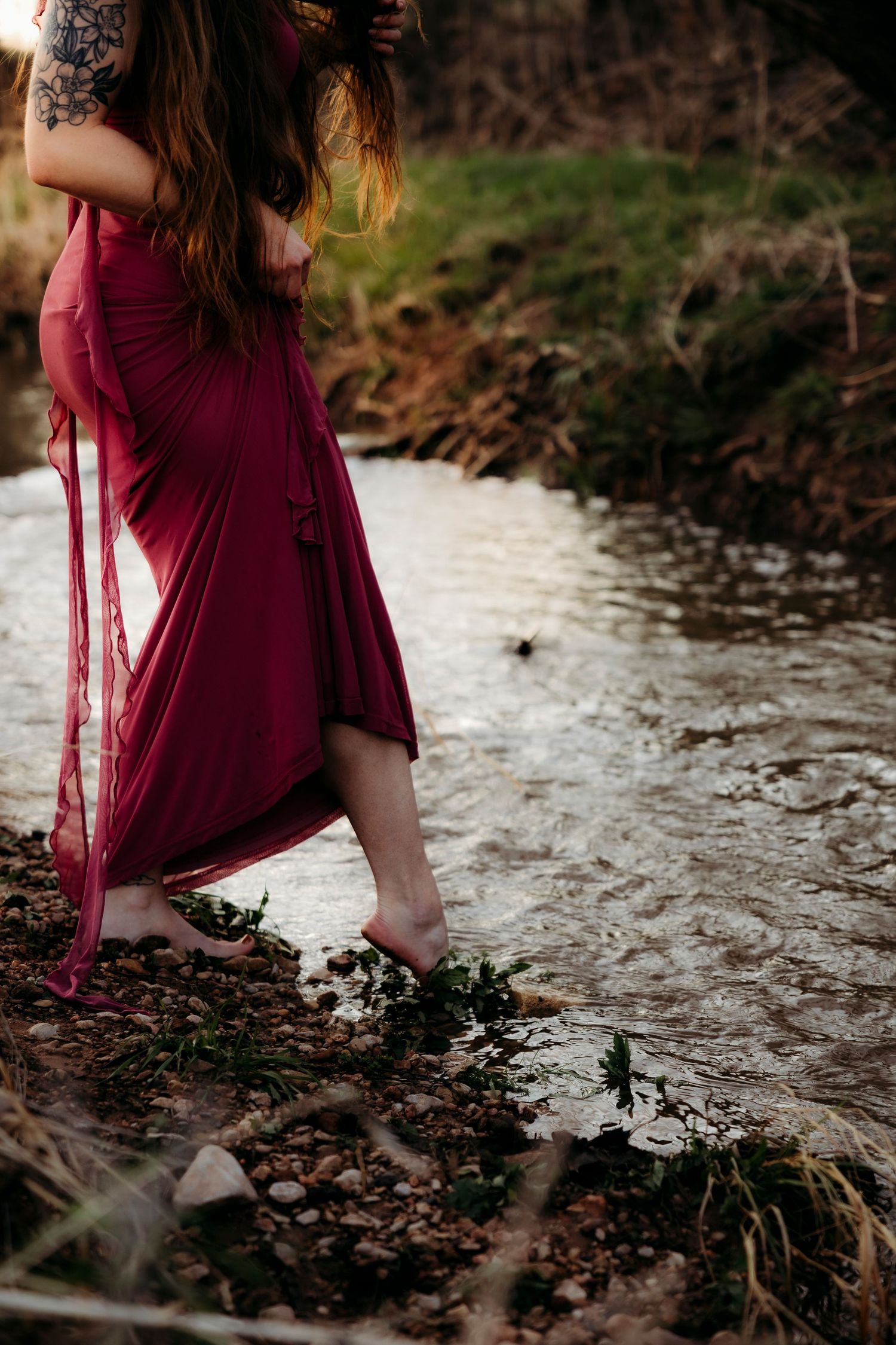 close up of creek styled photoshoot barefoot stepping into water in Abilene TX