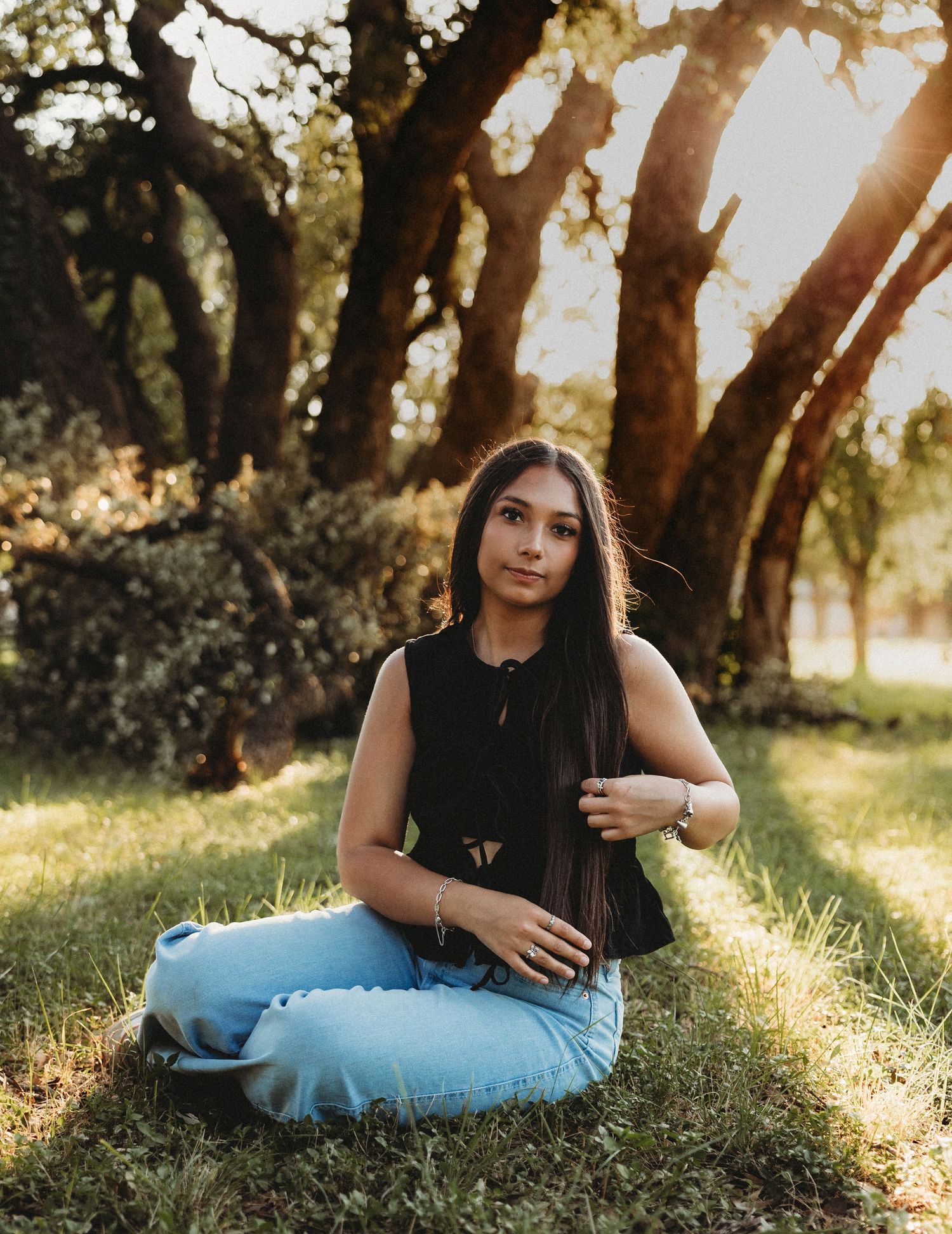 Class of 2027 senior portraits beneath oak trees during a golden hour senior session in Abilene, Texas.