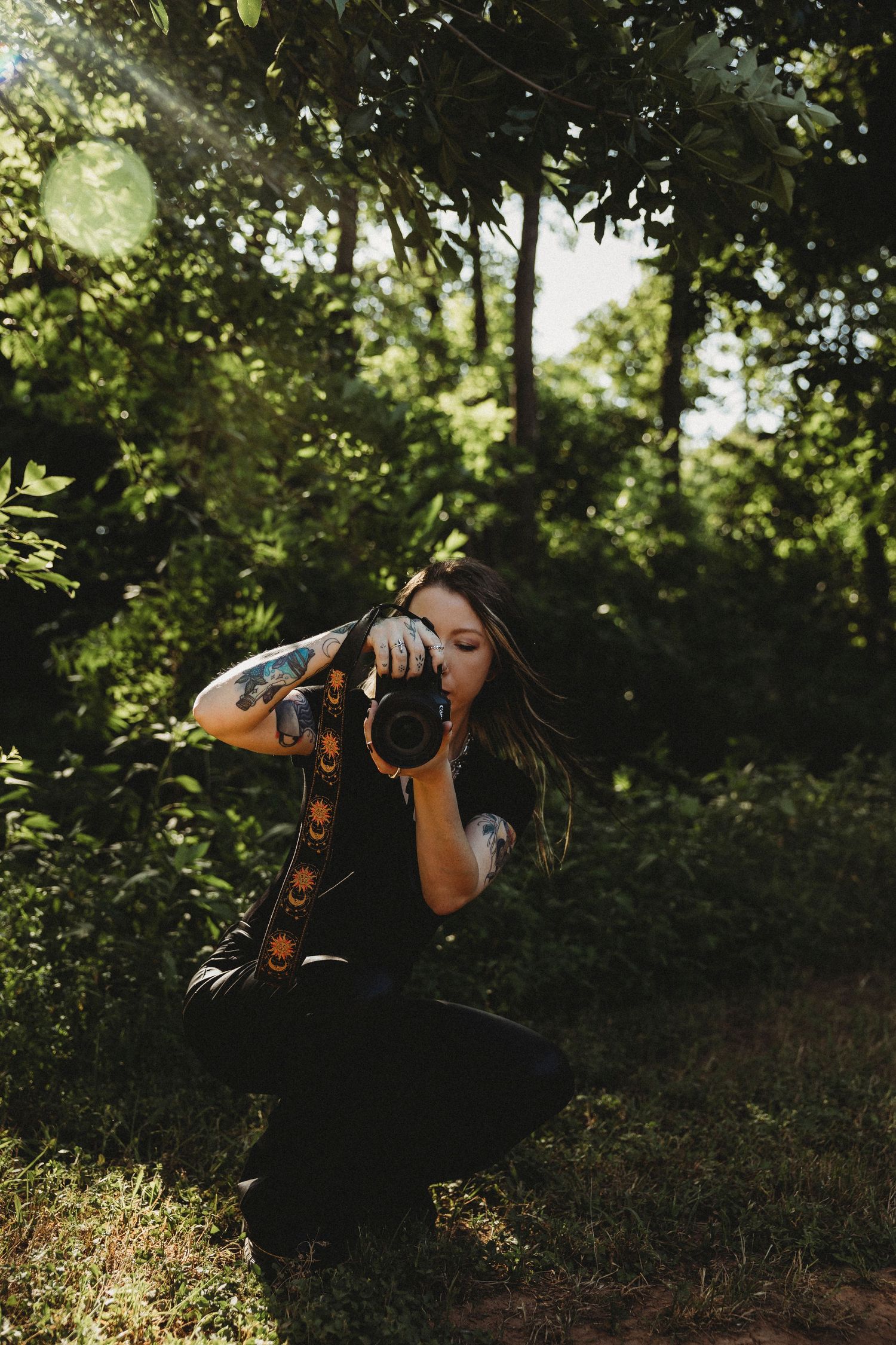 Photographer shooting outdoors during golden hour, capturing intentional imagery and creative storytelling.