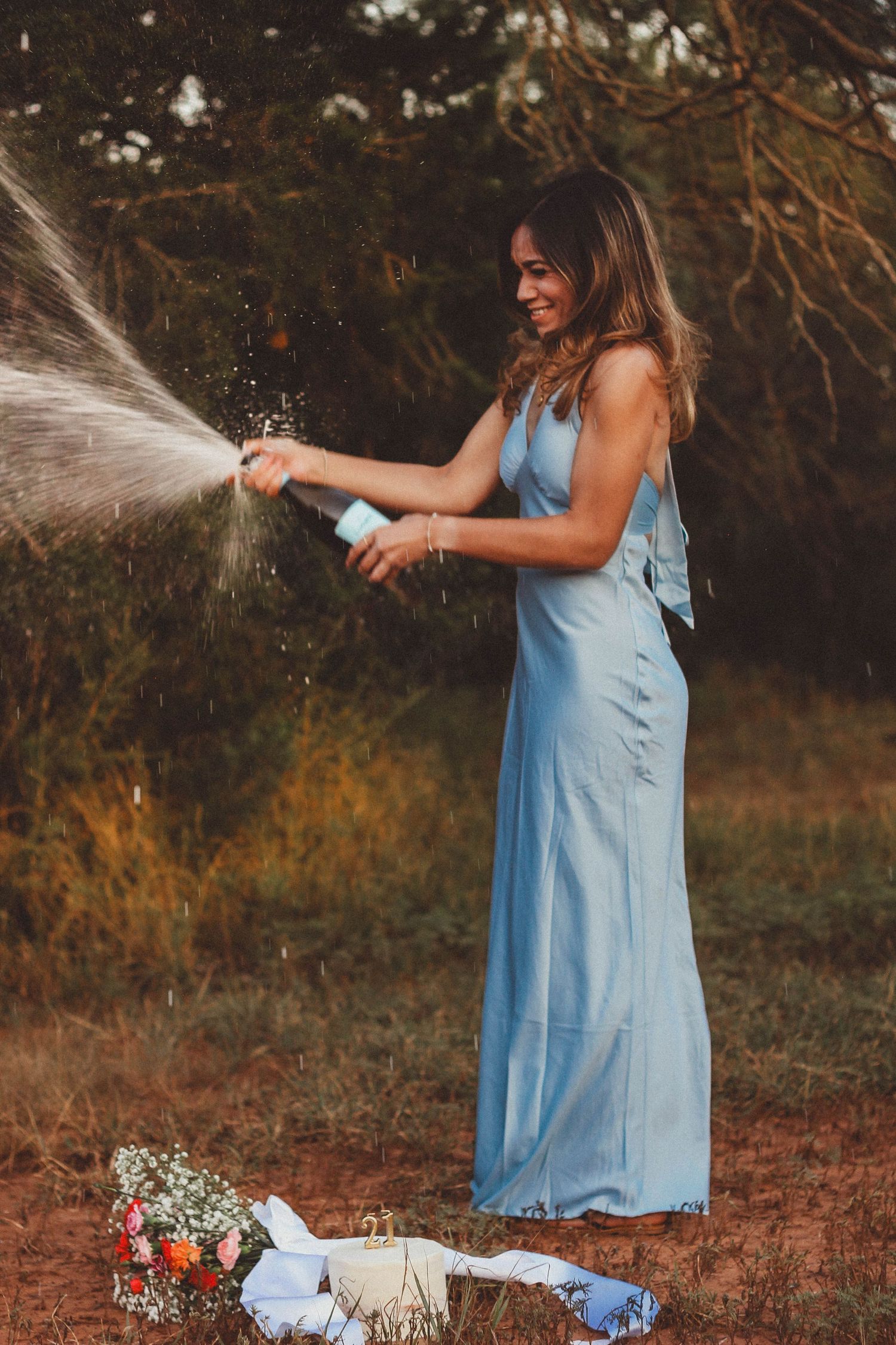 21st birthday portrait session in Abilene TX featuring a styled outdoor celebration with champagne and sunset light