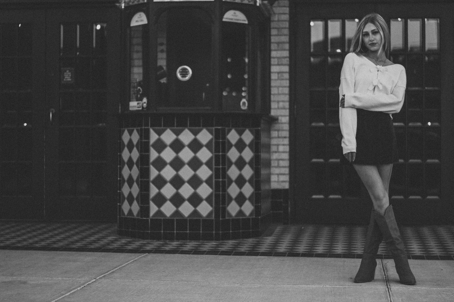 A black and white collage of vintage street scenes with storefronts and pedestrians on a city sidewalk.