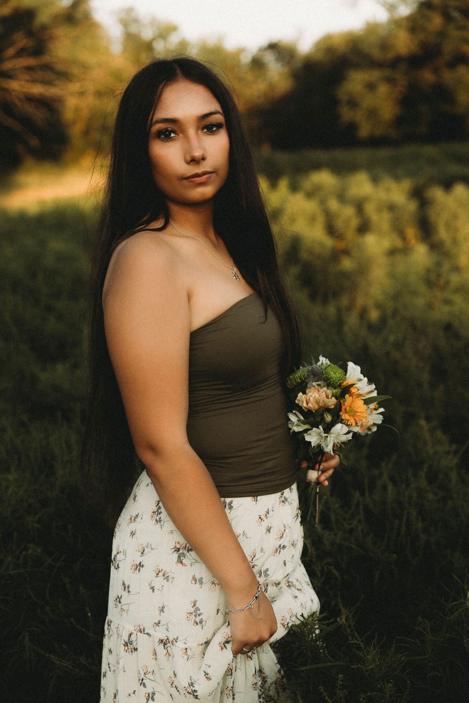 Class of 2027 senior portraits holding a bouquet during a golden hour senior session in Abilene, Texas.