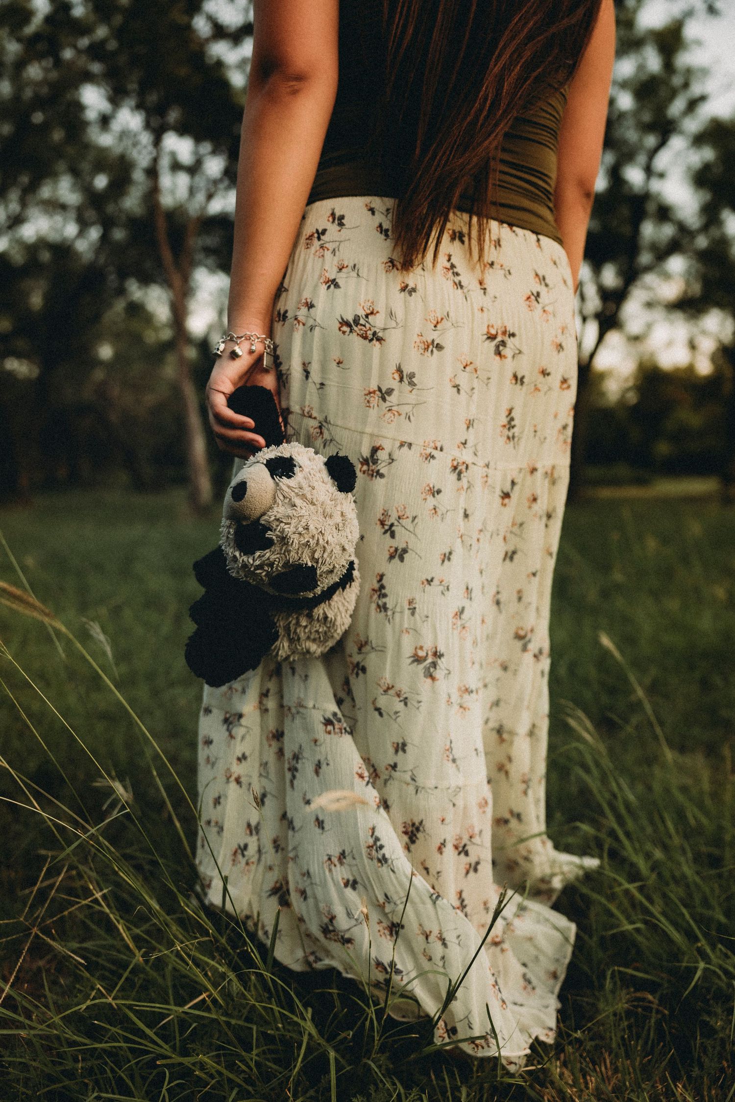 Class of 2027 senior photos featuring a floral dress and stuffed animal during a senior session in Abilene, Texas.