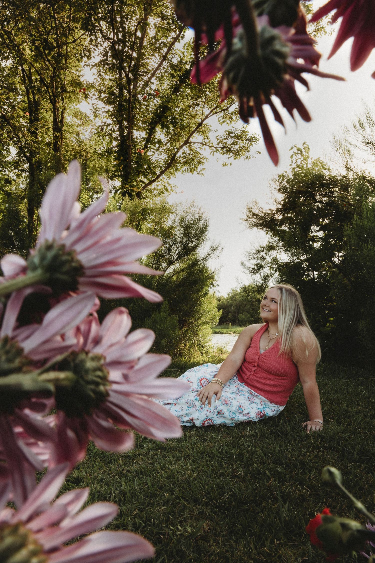 Creative senior portrait of a Wylie High School Class of 2027 senior framed by colorful flowers during a golden hour session in Abilene, Tex