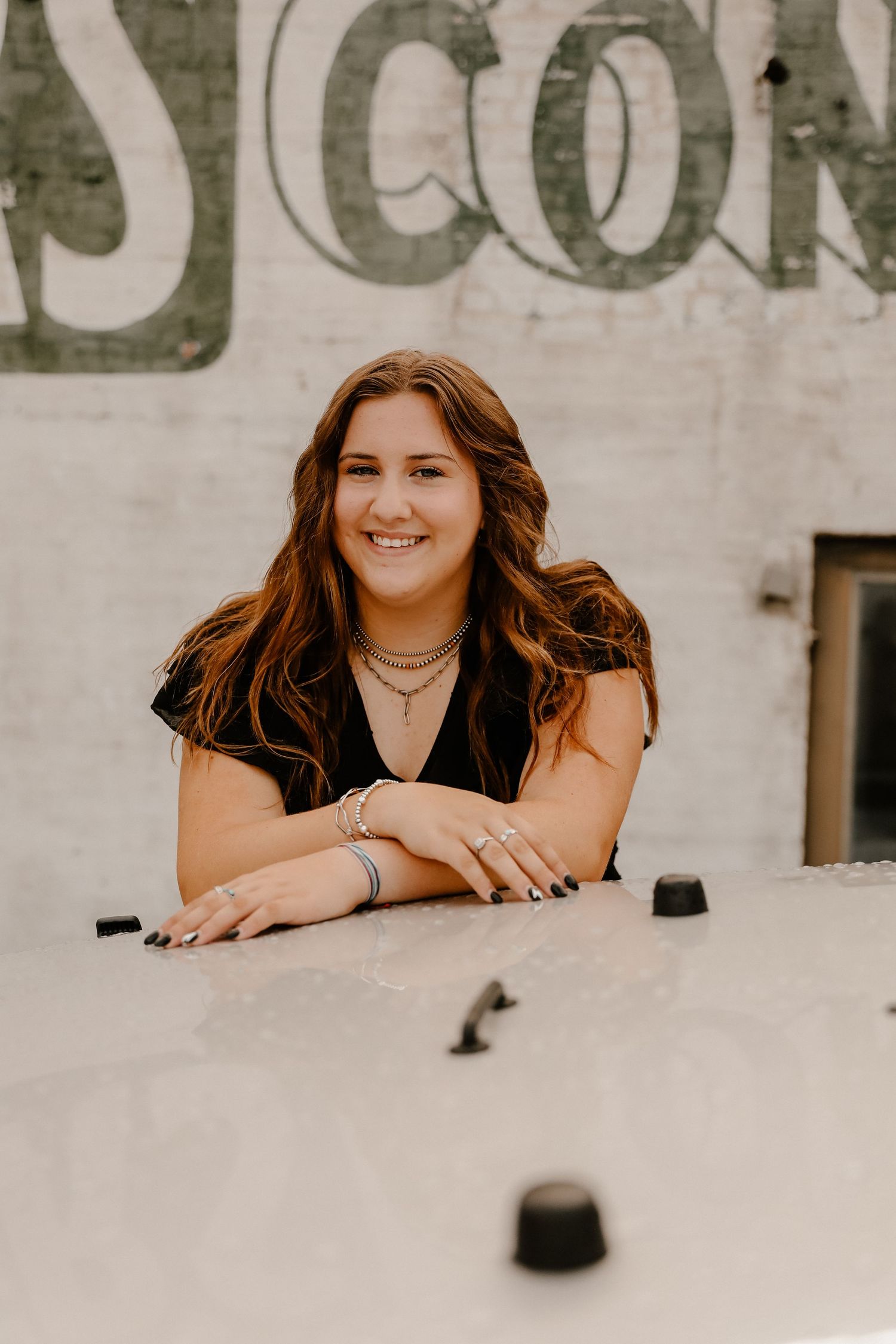 Series of casual portrait shots against a white textured wall background.