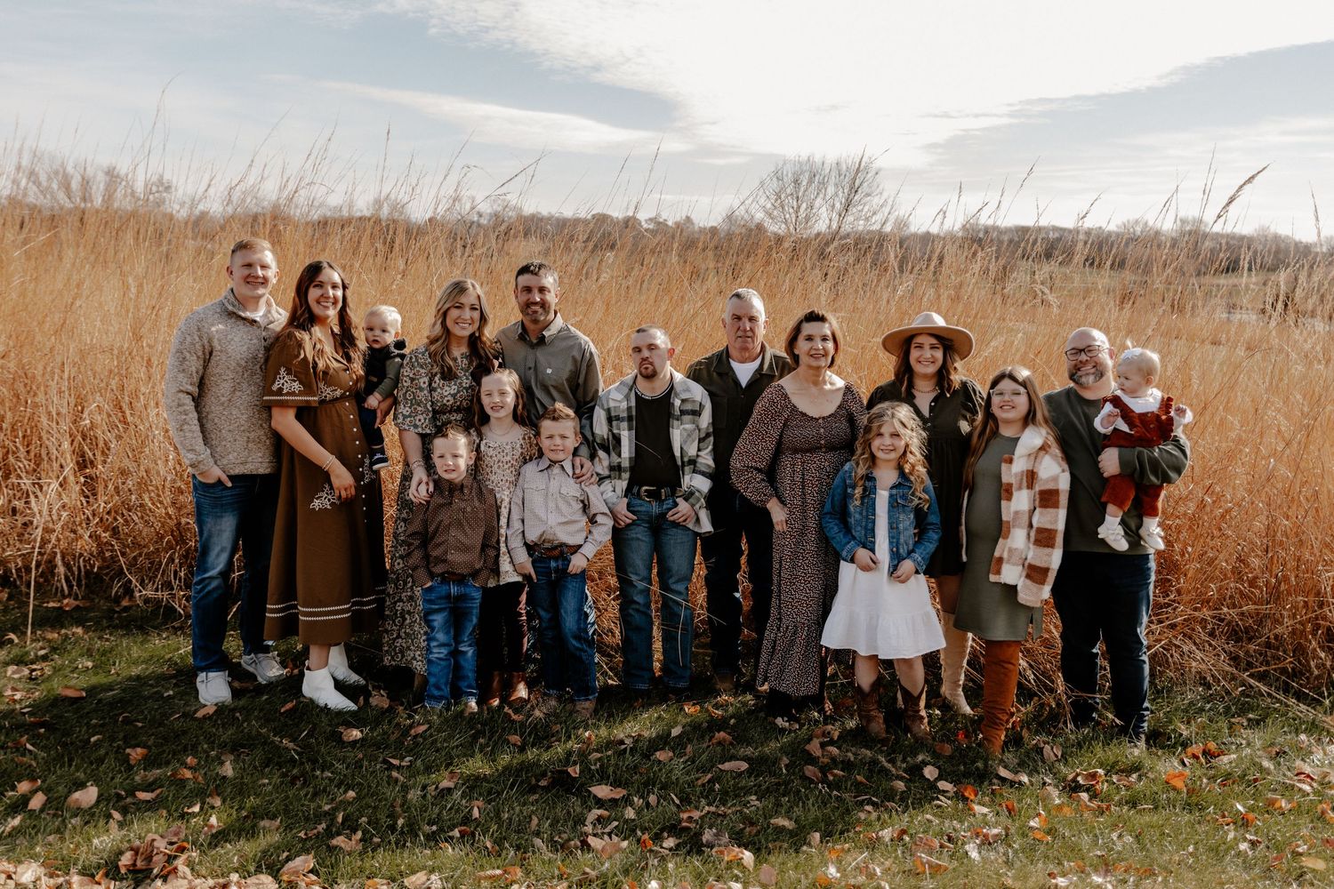Extended family group portrait series in outdoor autumn setting.