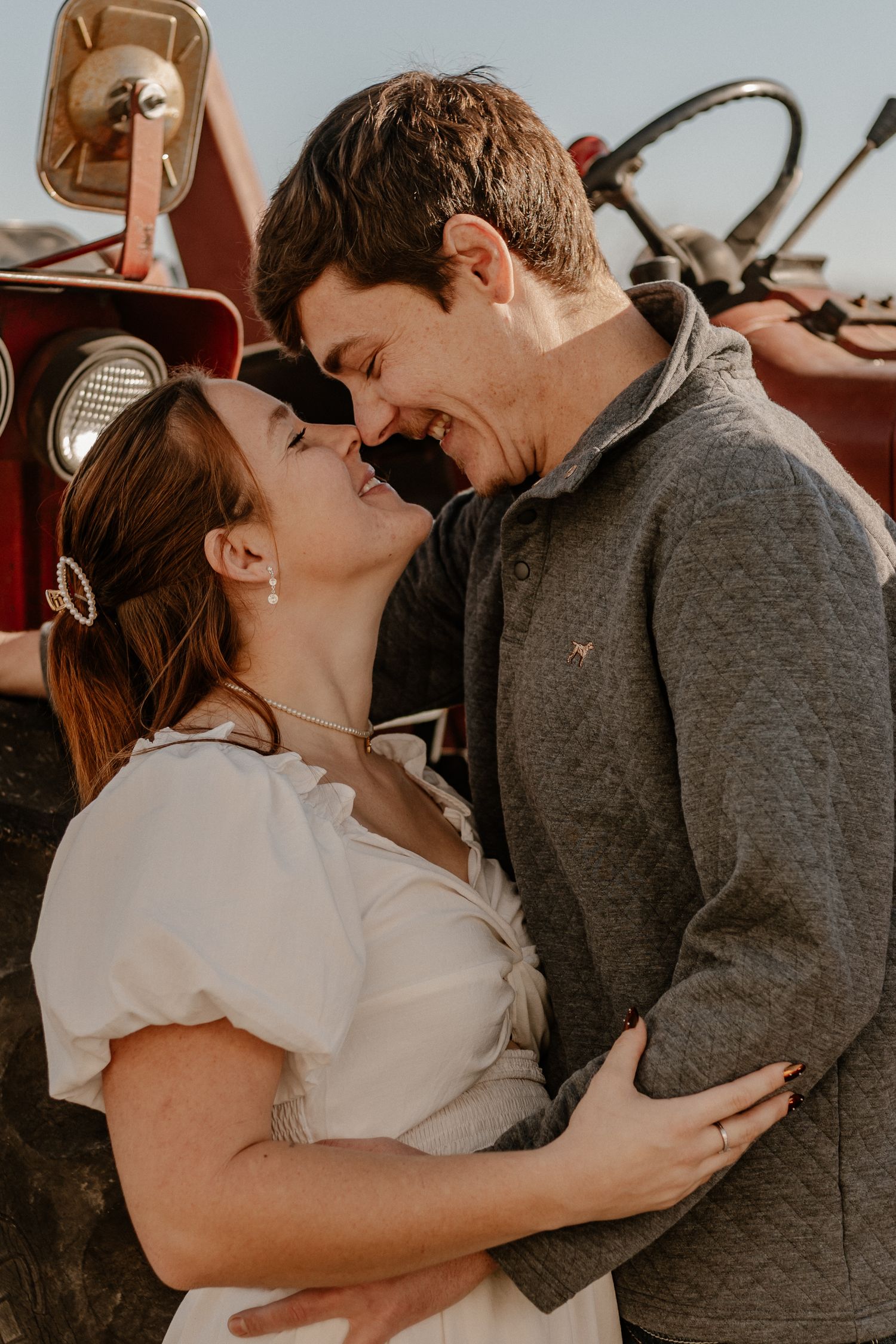 Romantic couple sharing tender moments in casual attire.