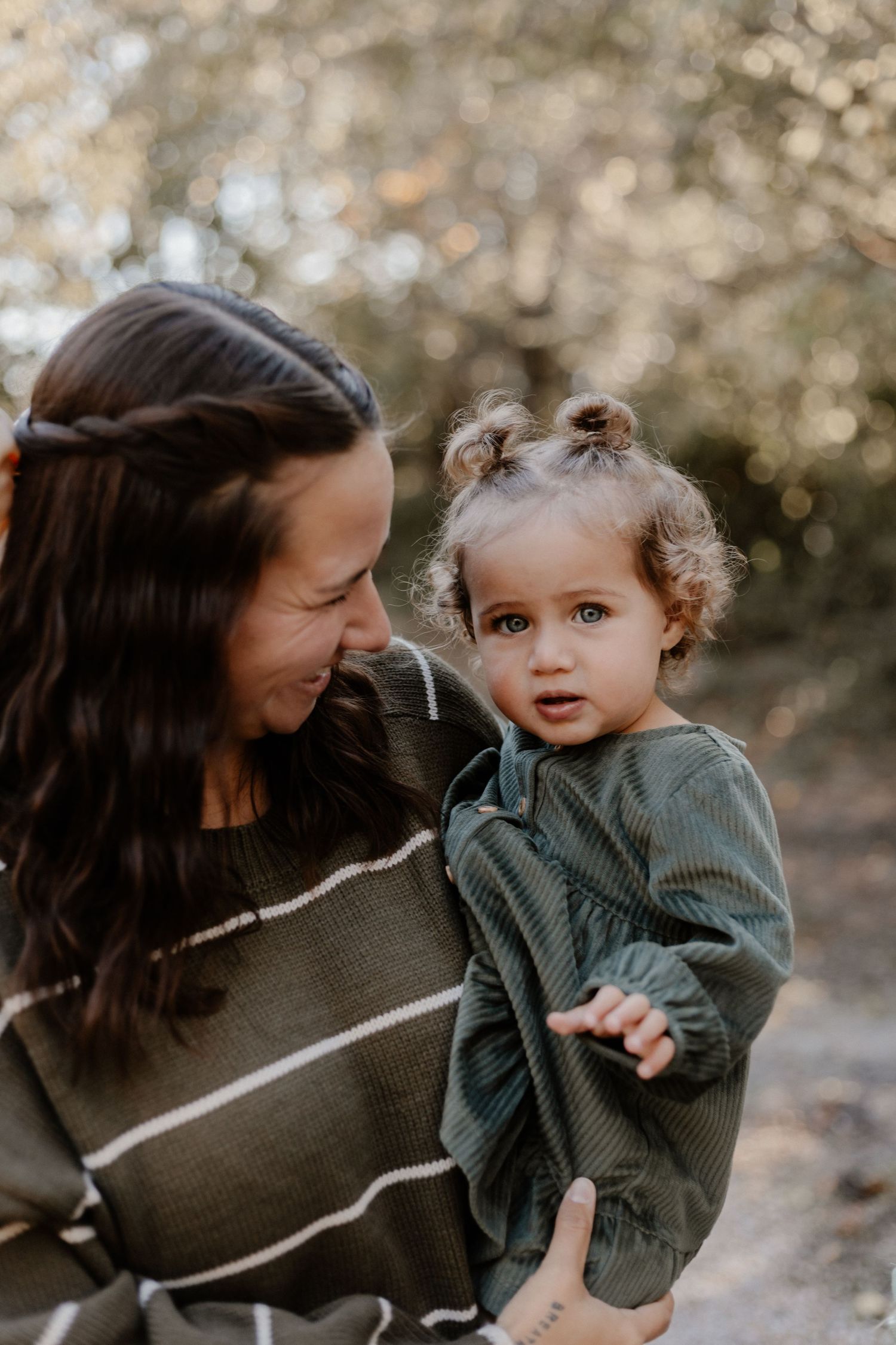 Tender mother-child moment captured in soft natural lighting.