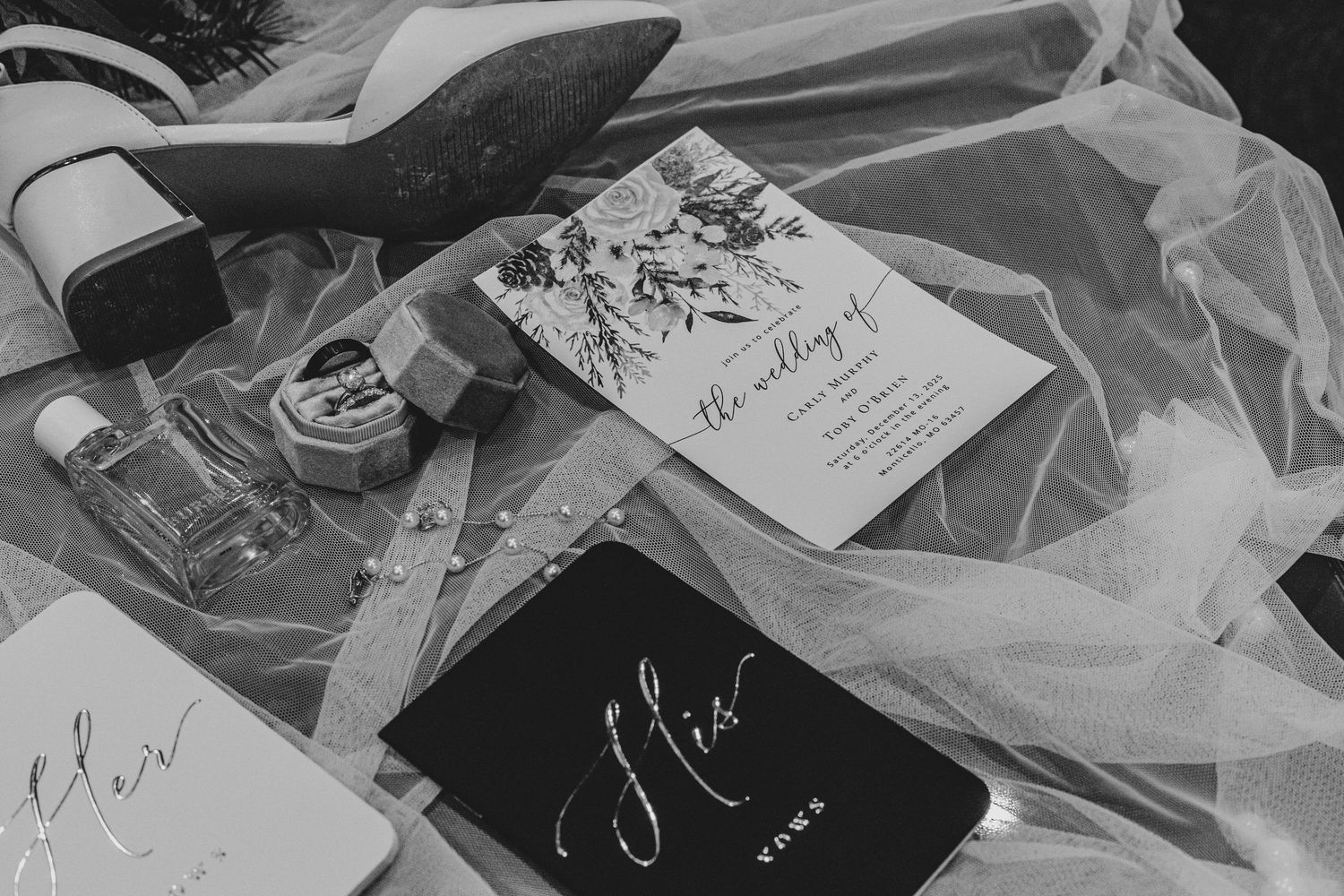 Wedding stationery and paper goods arranged in black and white.