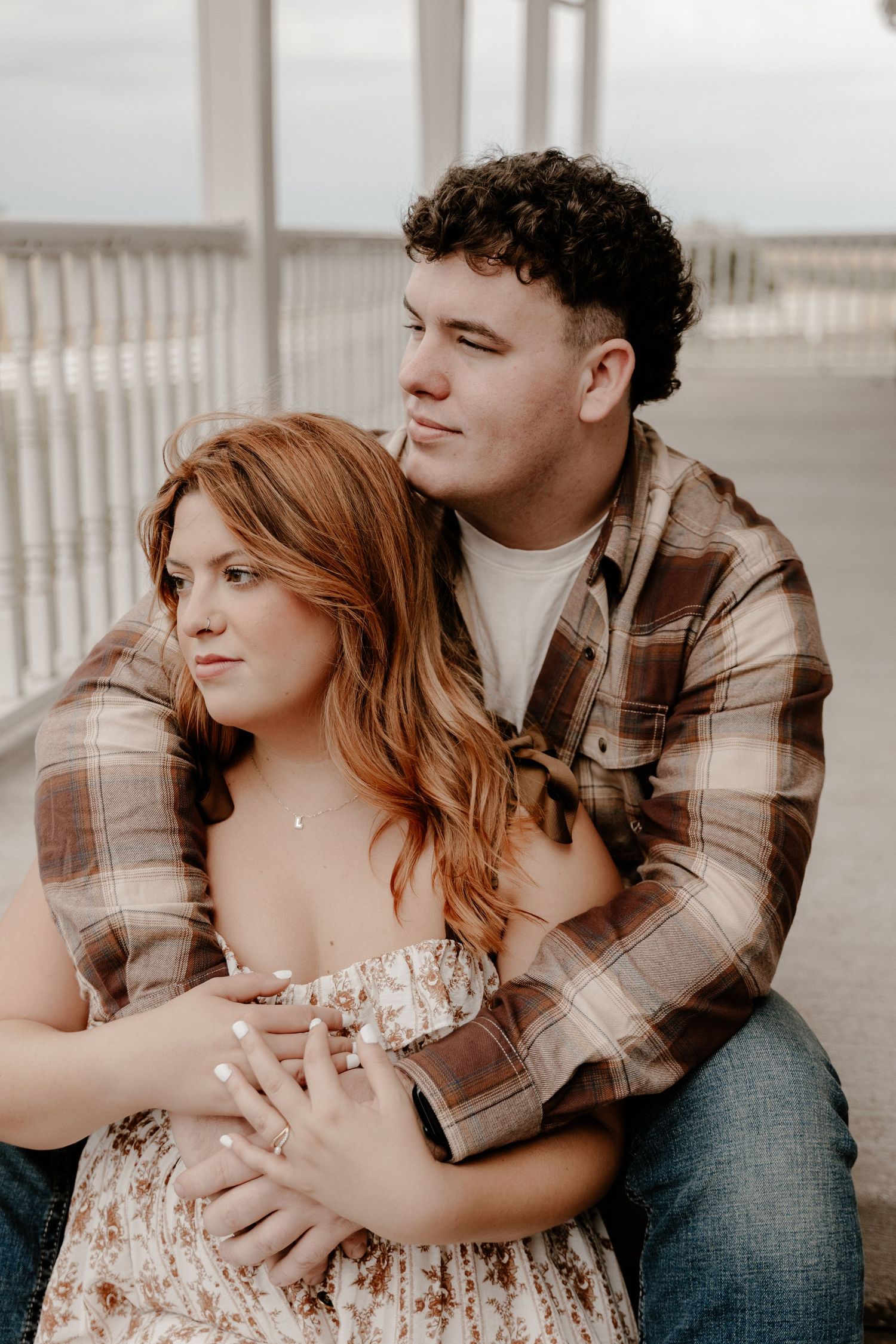 A tender embrace captured during a couples photoshoot outdoors.