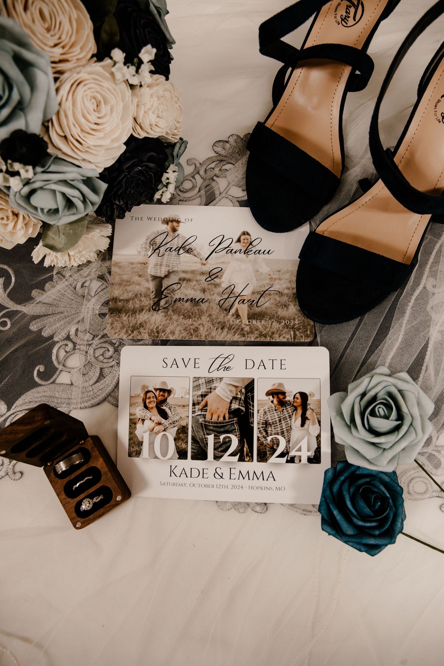 Wedding details flatlay with roses, black heels, and save the date cards.