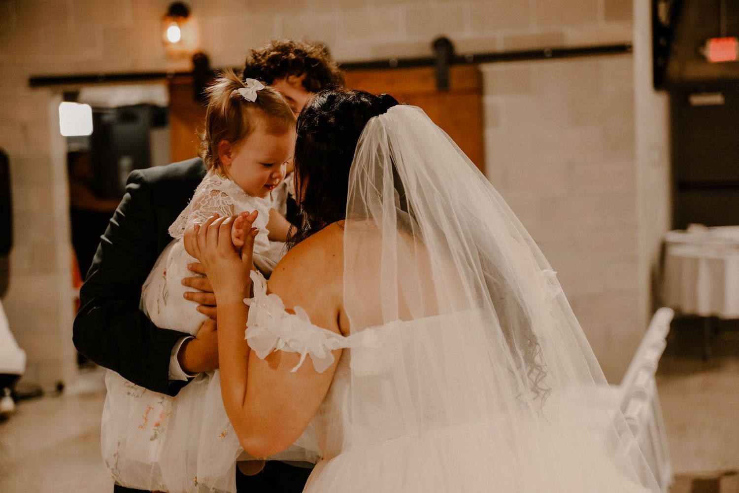 Romantic dance sequence in a light-filled venue with flowing white wedding dress details.