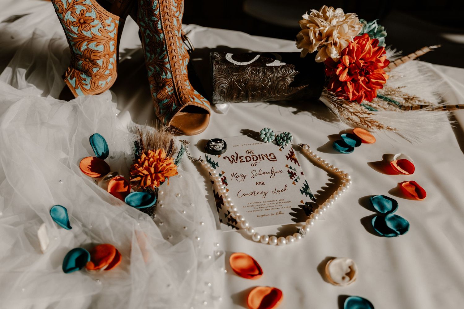 Scattered rose petals and decorative elements create romantic wedding table setting.