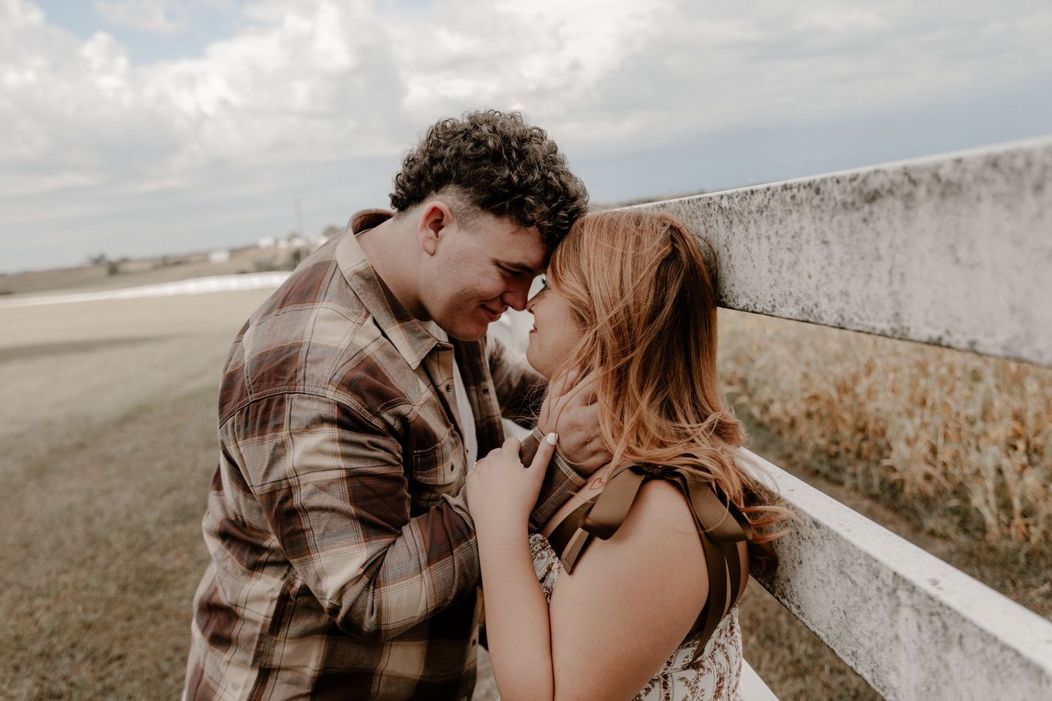 An intimate couples photoshoot in a rustic outdoor setting.