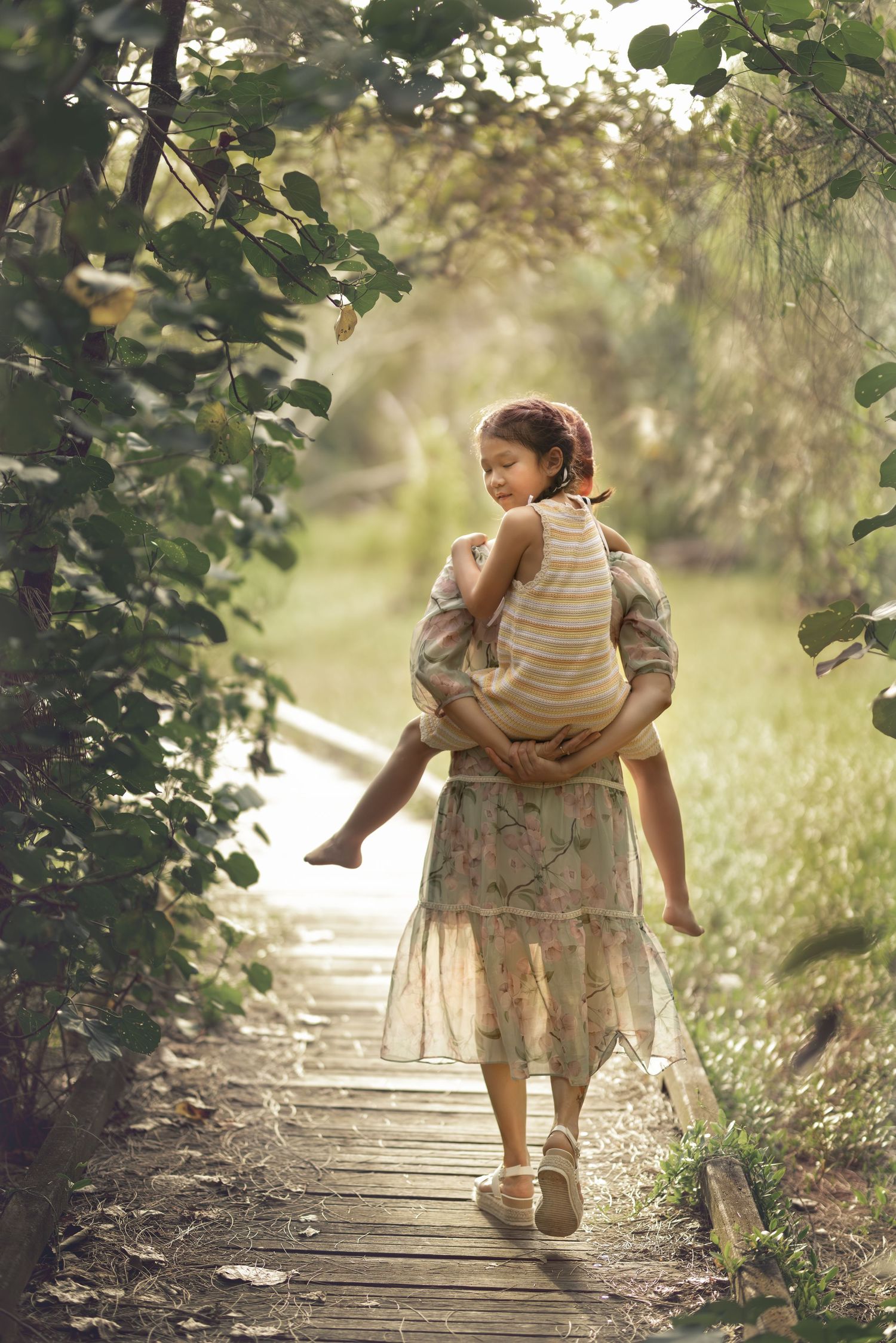 Mother carrying child on wooden bridge - Outdoor family photography Brisbane