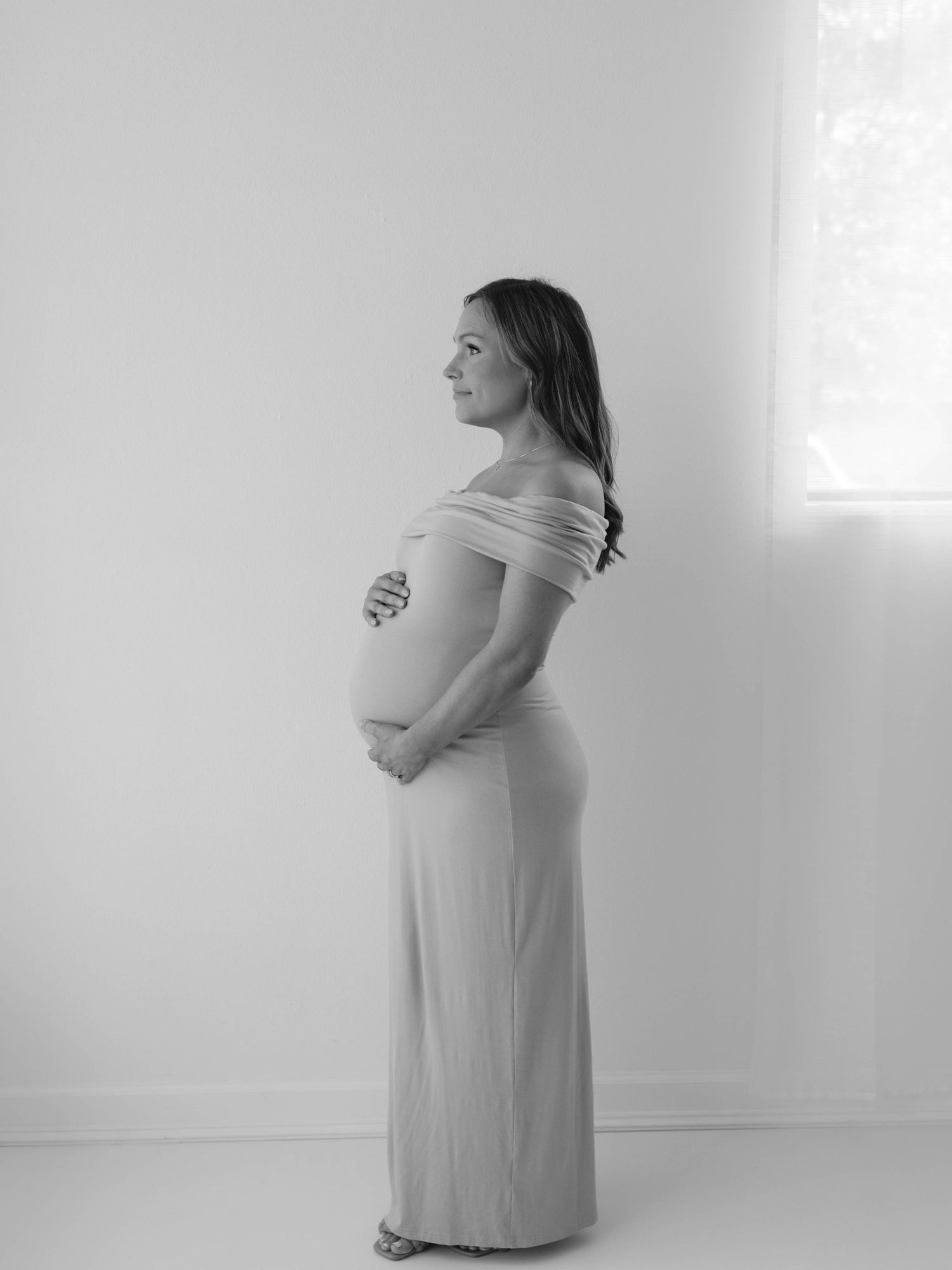 Pregnant mother in dress in natural light studio- St. Louis, Missouri maternity photography