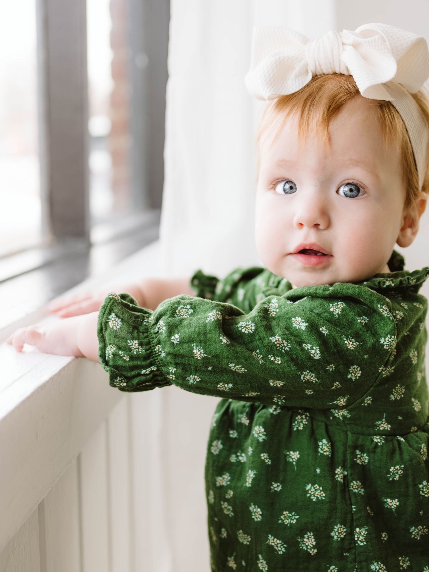 One year old little girl milestone pictures in white natural light studio in St. Louis Missouri