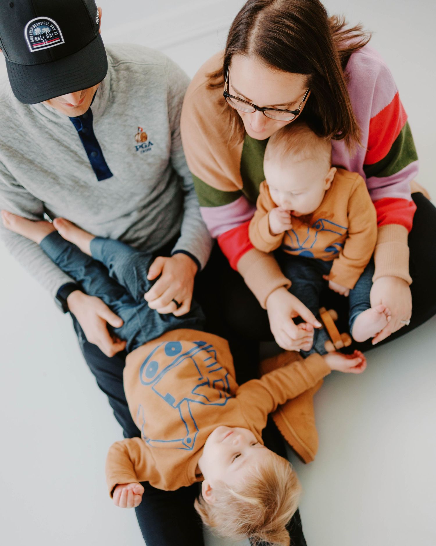Family of four milestone pictures in all white studio in St. Louis Missouri