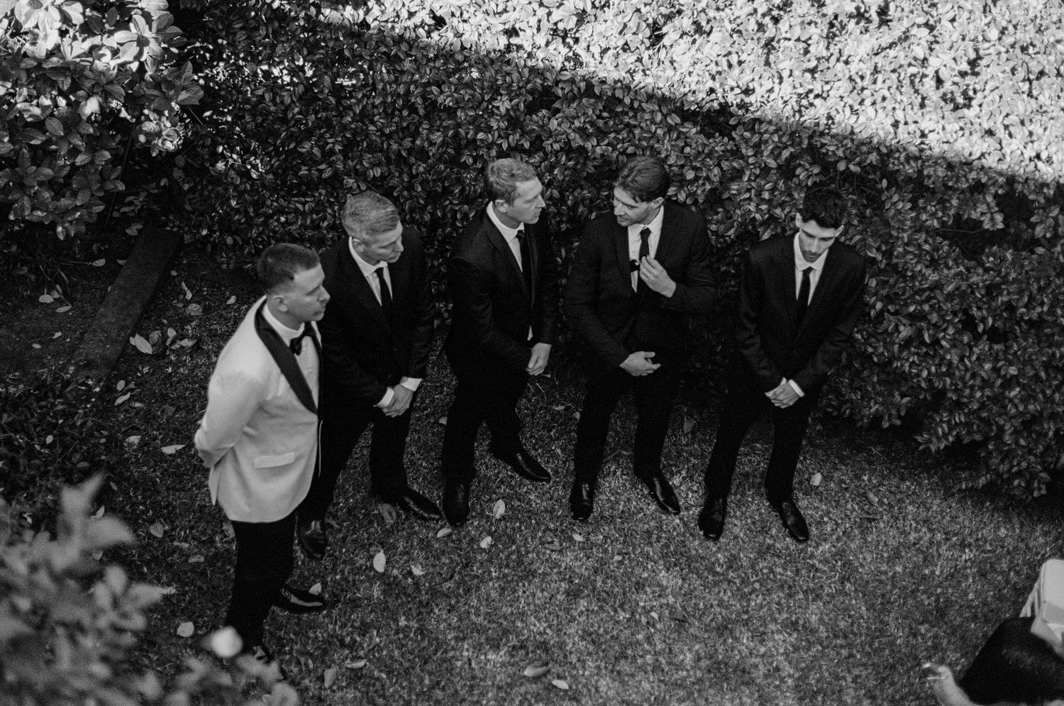Wedding party in formal attire photographed from above in black and white.